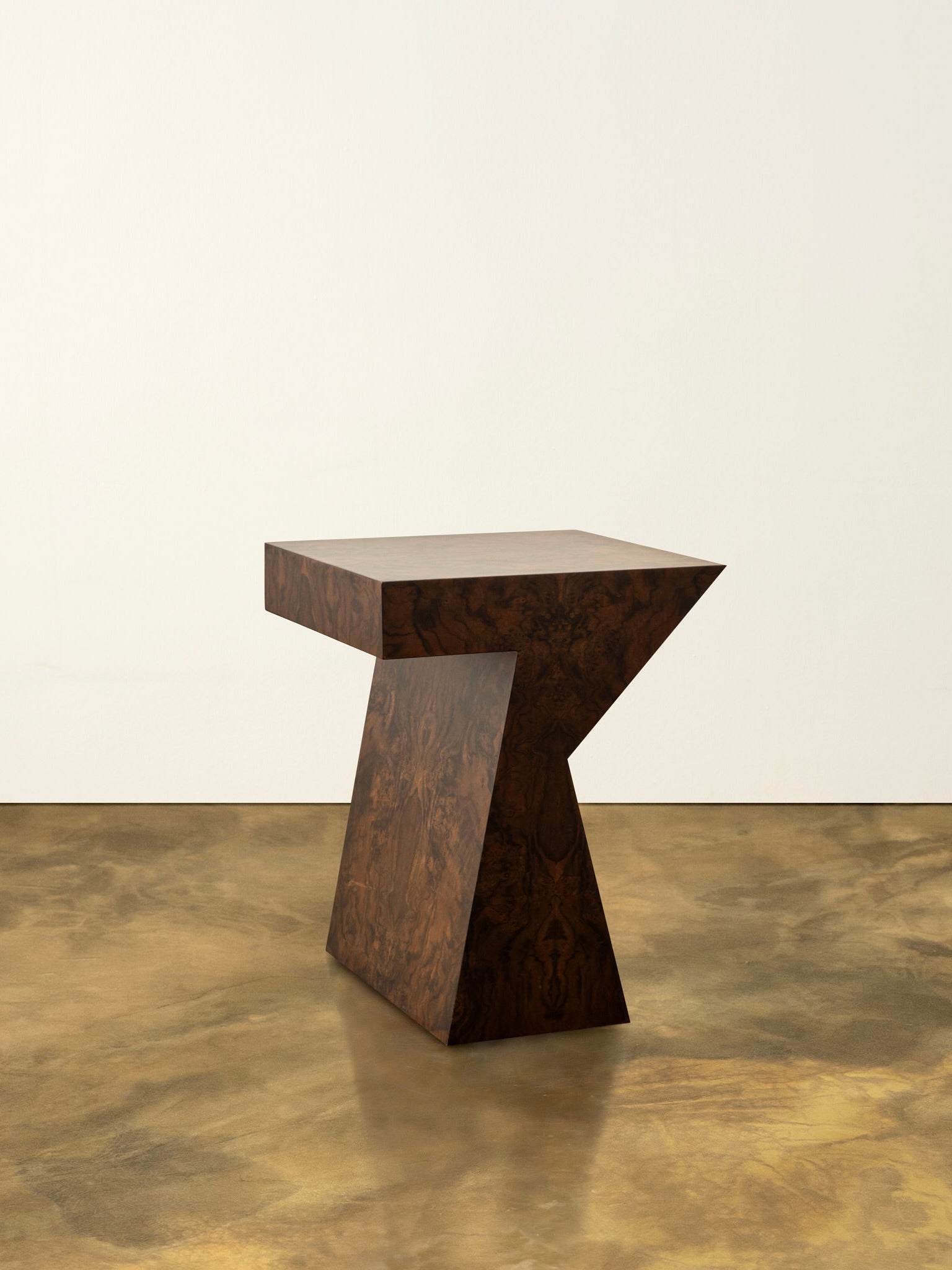 The "Columbina" side table by Animate Objects is a modern geometric piece handcrafted in Istanbul using walnut burl veneer.