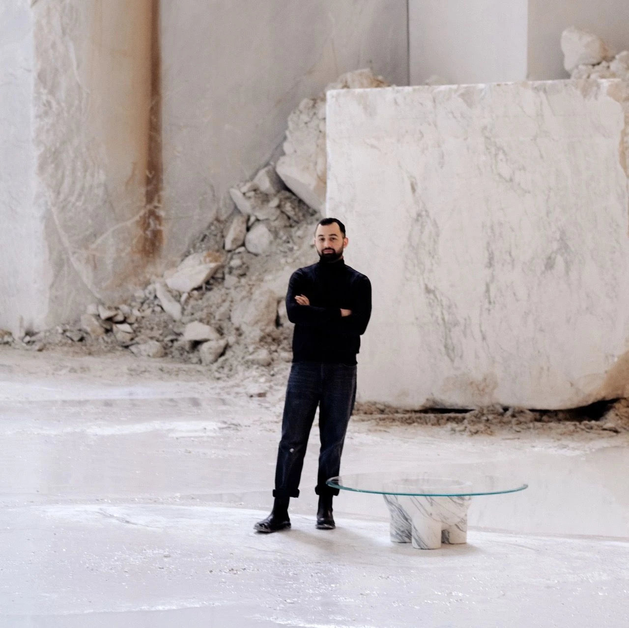 A cylindrical stone vase filled with fresh lemons is placed on a minimalist concrete floor. The image captures the serene and modern aesthetic of the scene.