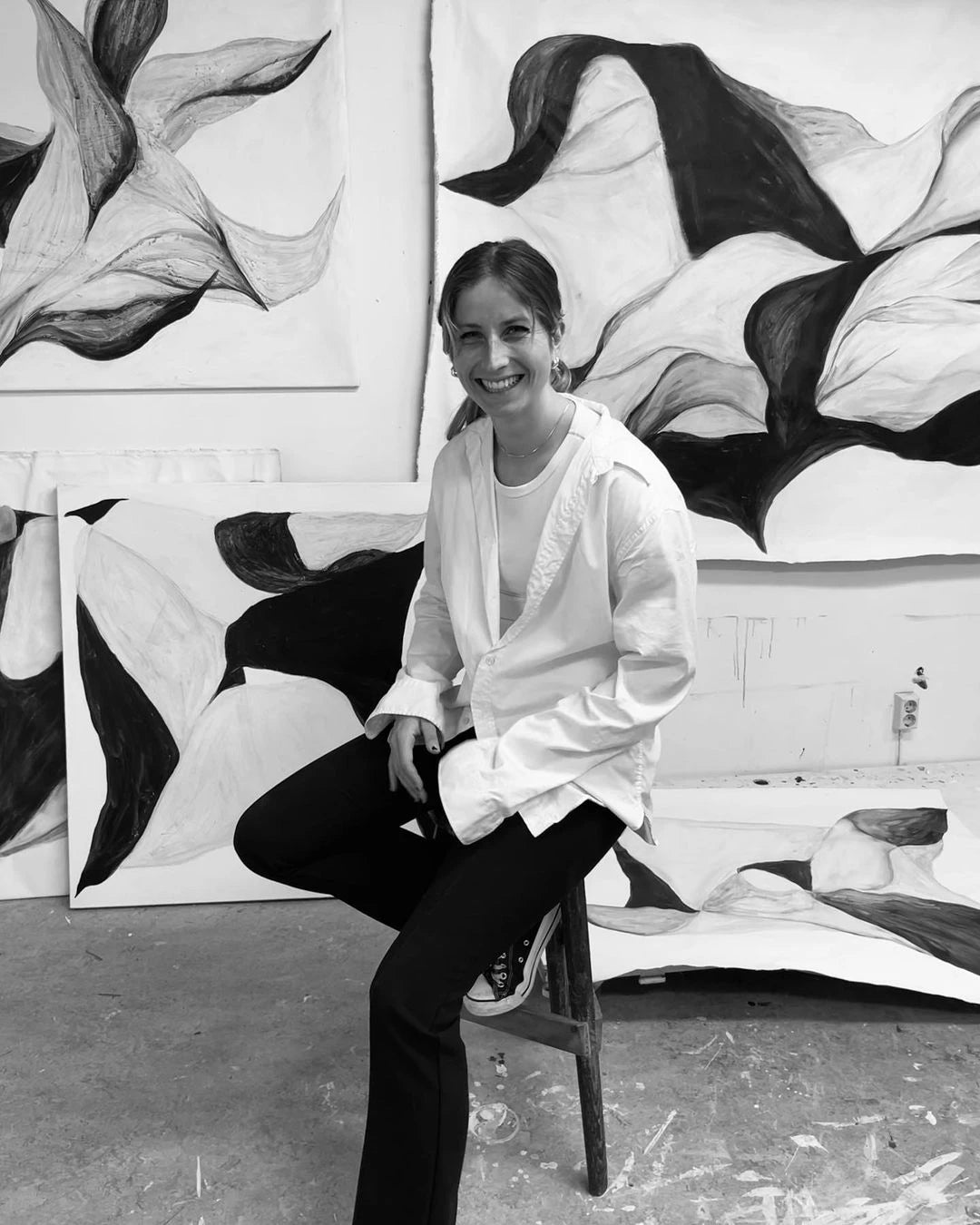 An abstract painting divided into two halves, one black and one white. Flowing shapes in shades of green, blue, and white intertwine in the center, creating a dynamic and visually balanced composition. Framed in wood.