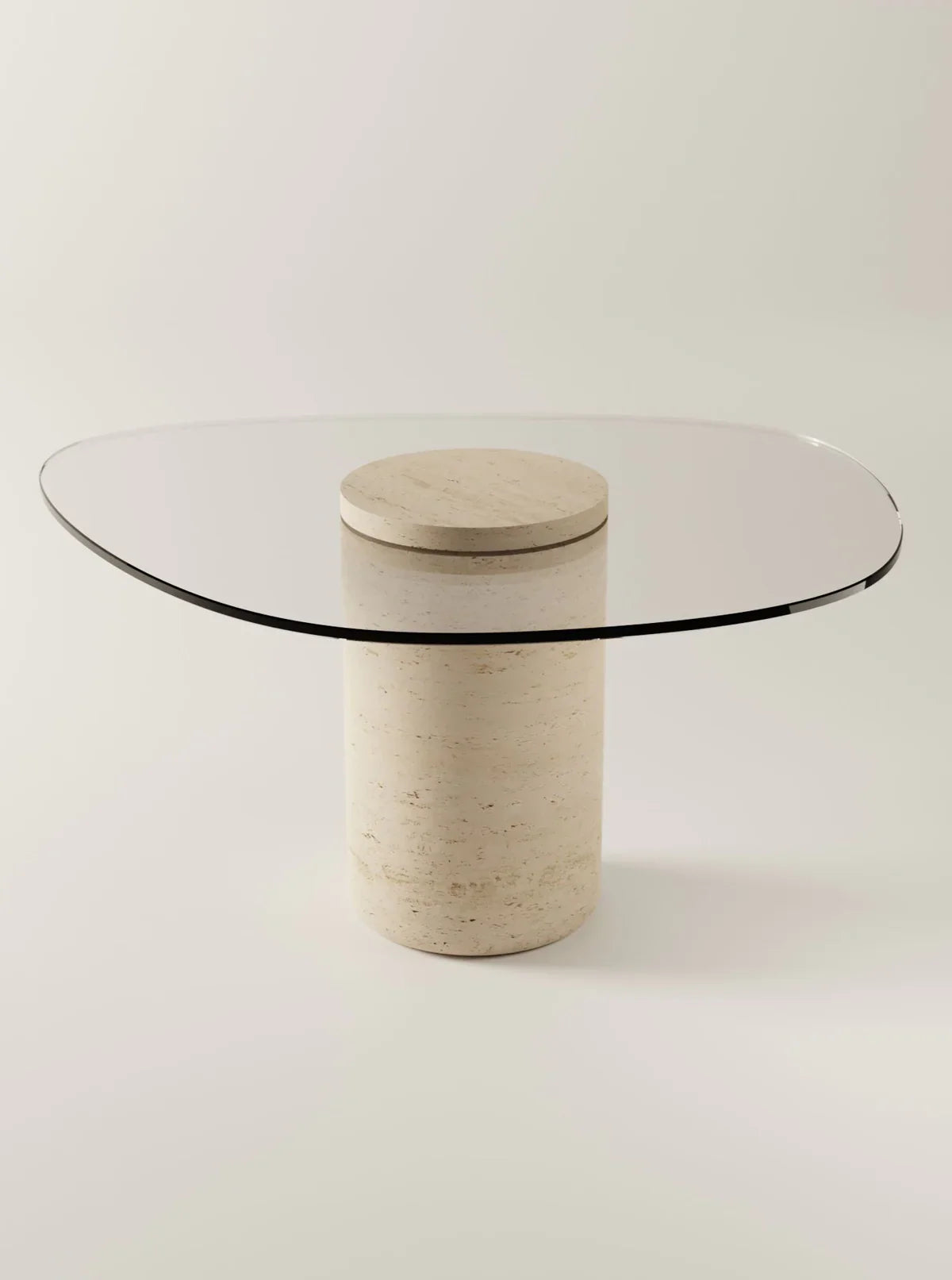 Modern dining table glass-top table with an oval shape, supported by a cylindrical beige stone base. The design is minimalistic and elegant, blending natural stone texture with contemporary glass elements.