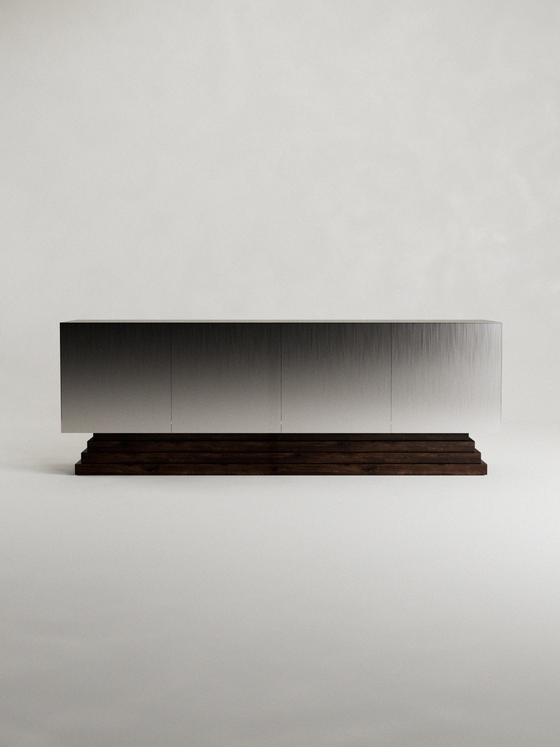 The 'Fragua' Sideboard by Siete Studio features a sleek modern design with a metallic brushed surface atop a dark tiered walnut base, showcasing minimalist design and artisanal craftsmanship against a plain white background.