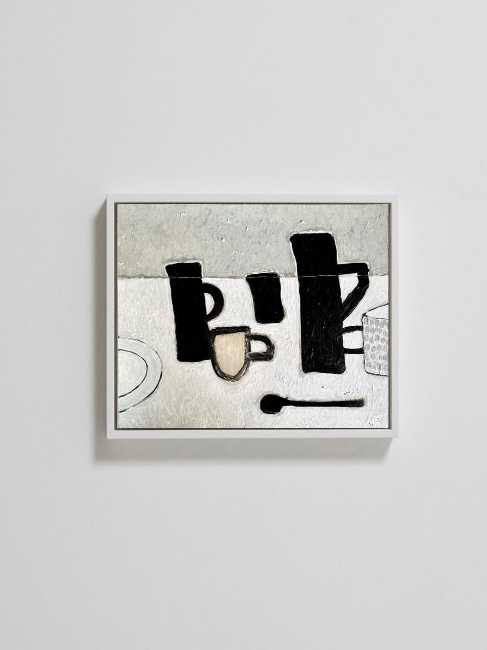 The "Three Black Jugs" painting by Lara Voce is an abstract naive-style acrylic work on a cradled wooden panel, featuring bold black shapes like cups and utensils against a textured white and gray background. It is displayed on a plain white wall.