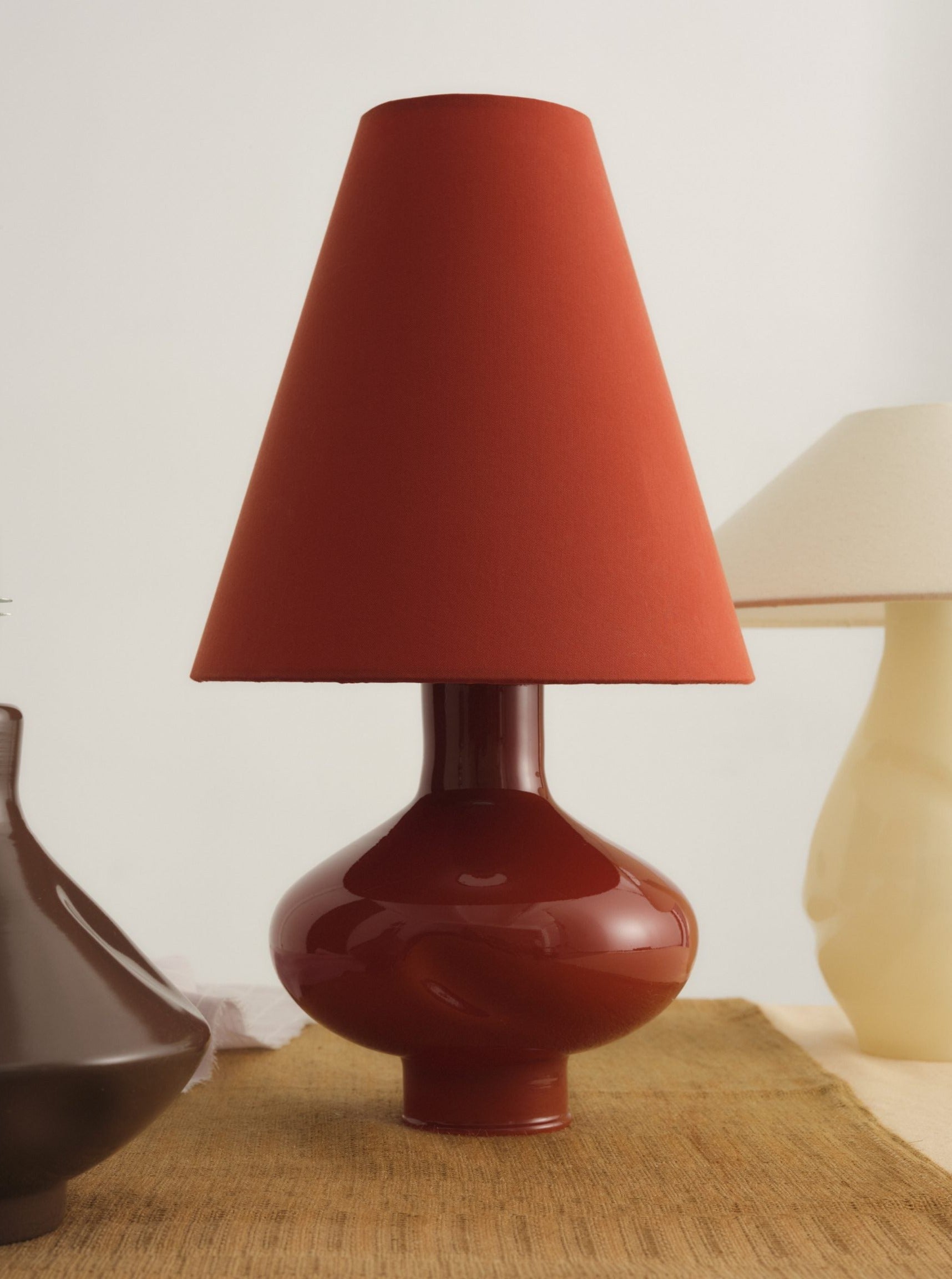Dark red conical glass lamp II with intricate gold detailing and curved base