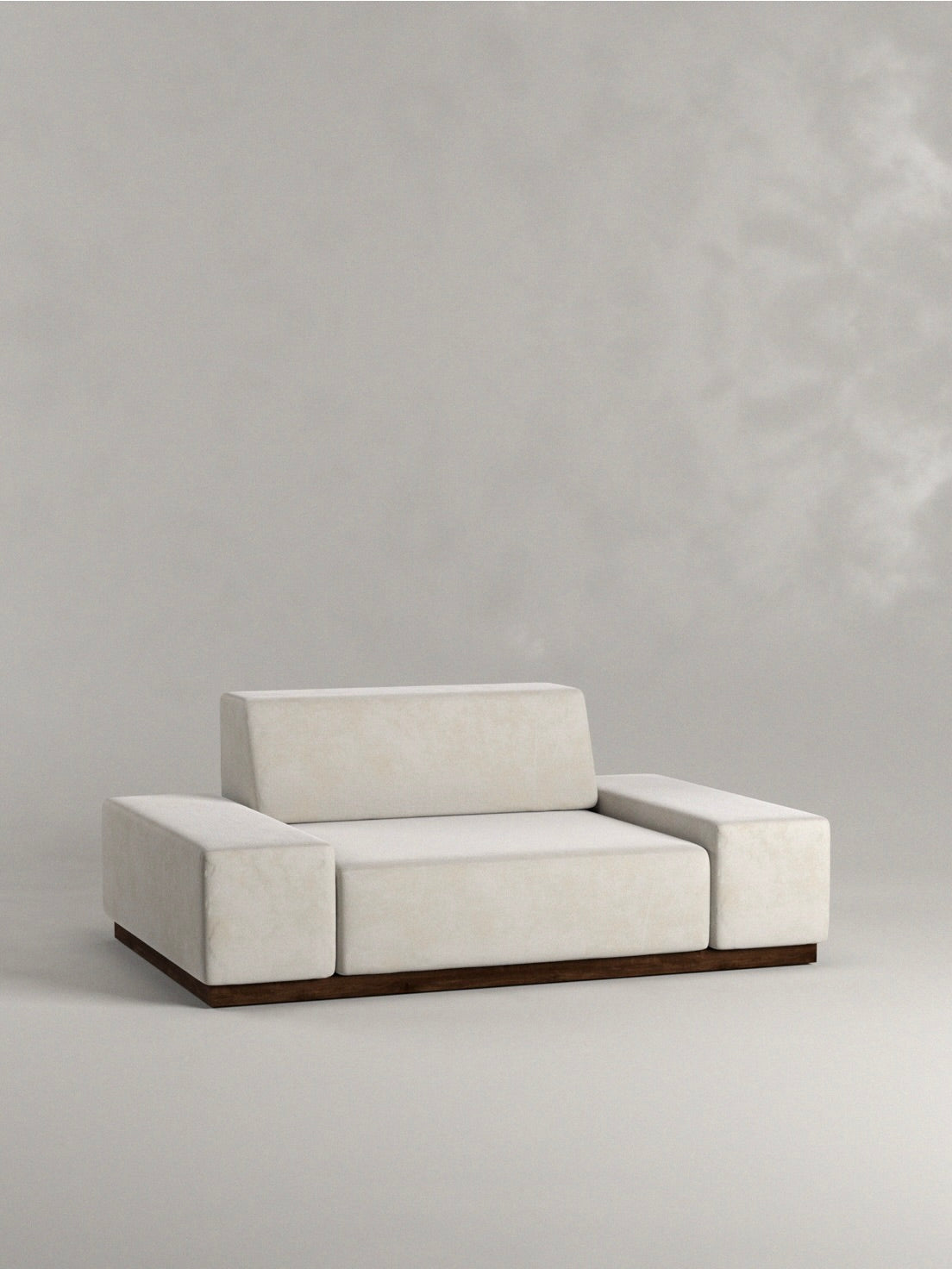 The 'Nube' Sofa by Siete Studio captures 70s Italian design with a minimalist white look, low armrests and backrest, set against a neutral background, supported by a solid walnut base.