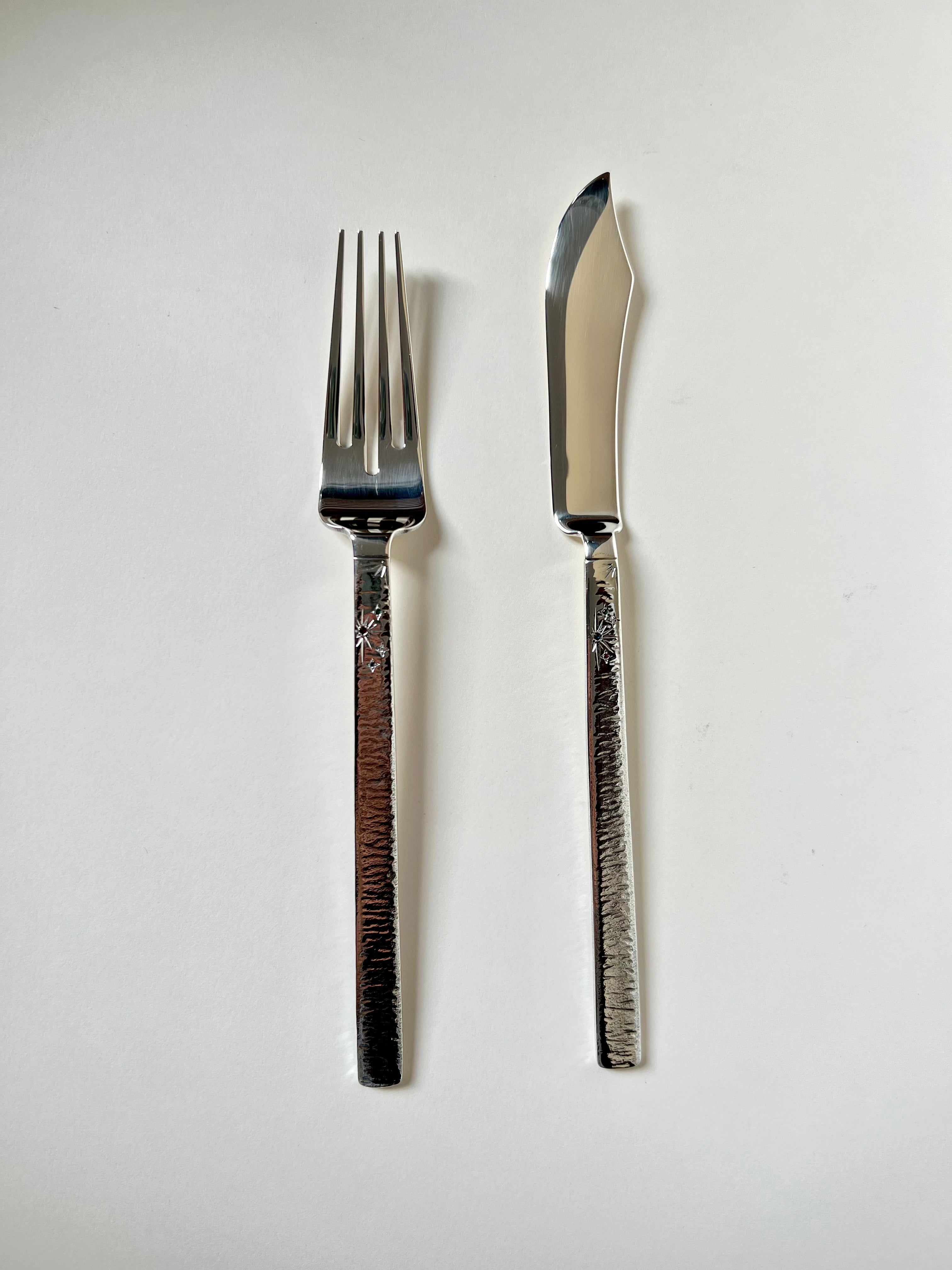 Shiny 2 piece silver cutlery set with ornate handles and sleek design