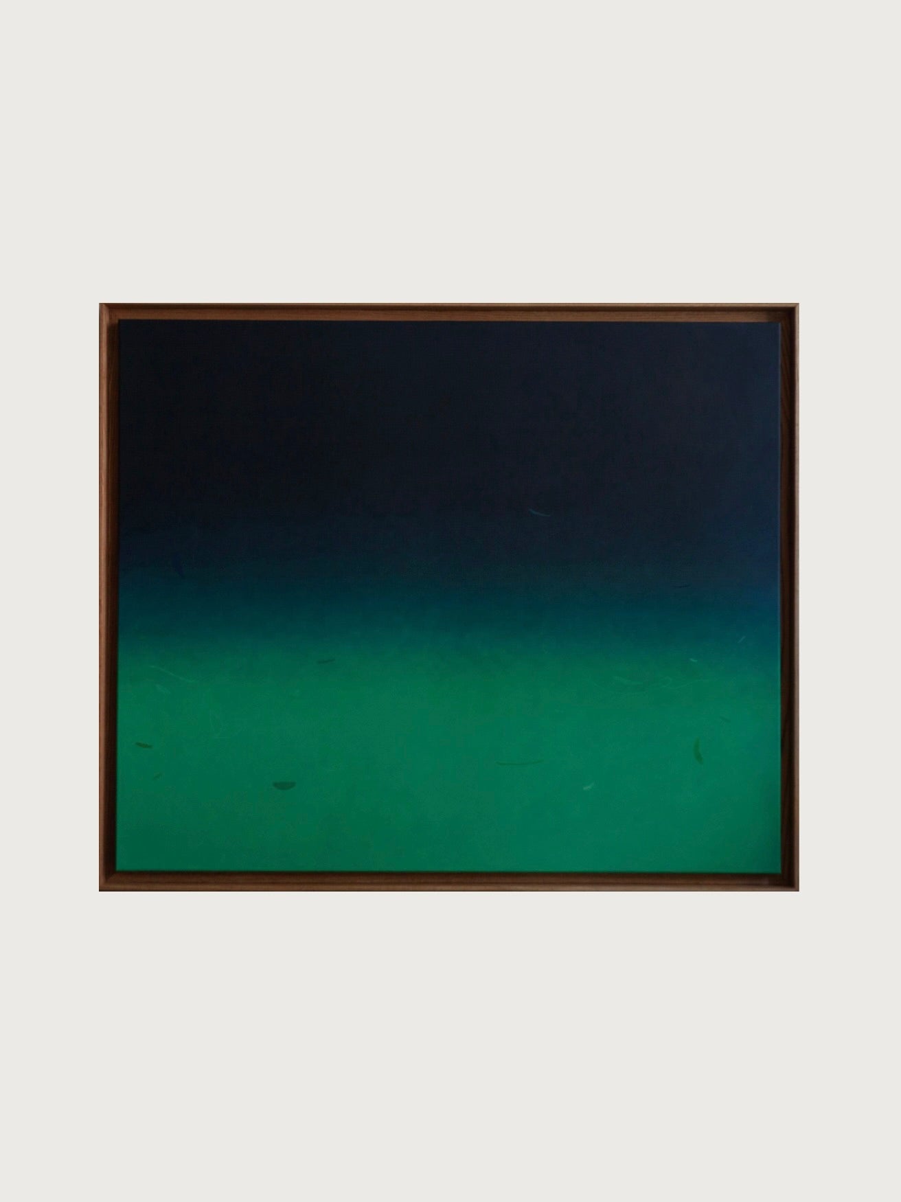 Beneath and Below" by Rebecca von Matérn, a 2024 acrylic painting on canvas, showcases a gradient transition from dark blue at the top to deep green at the bottom against a light gray background. The colors blend smoothly within a shadow frame of hard waxed oak, creating a tranquil and serene effect.