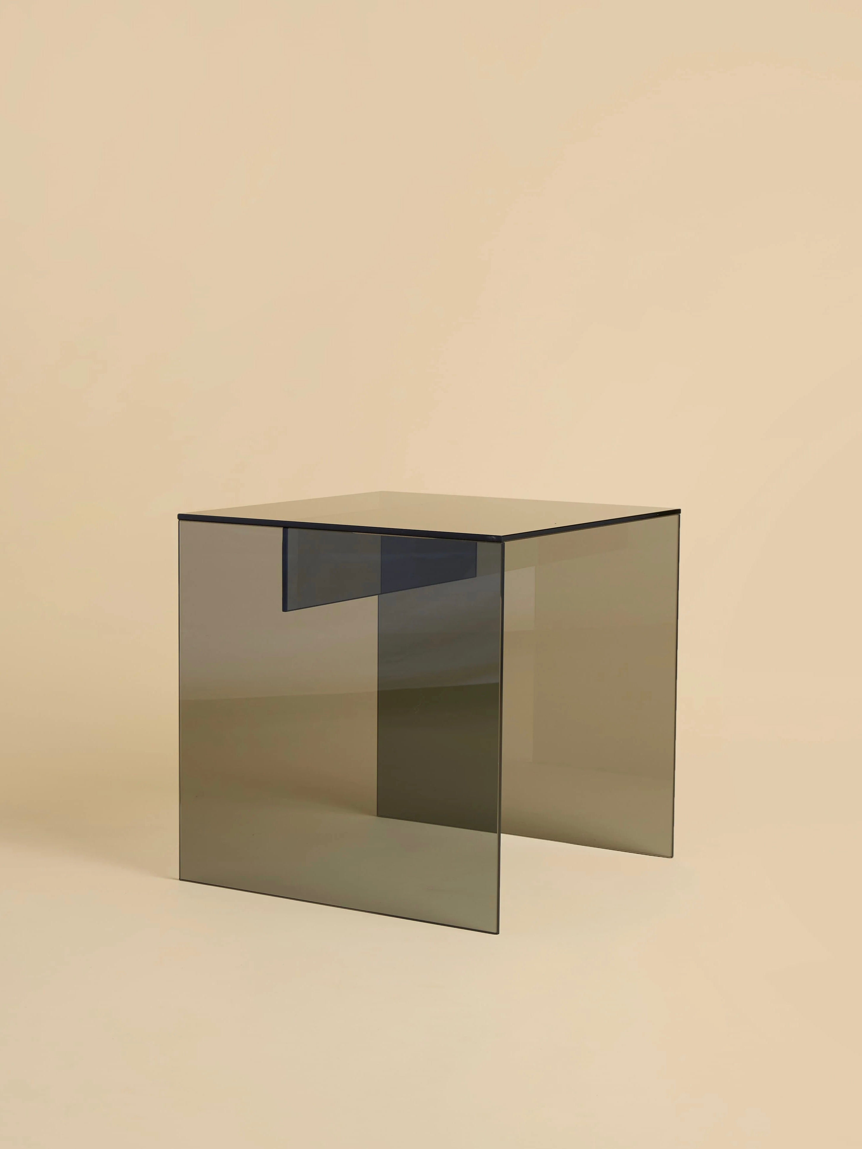 The Lebanto "Honshu" Smoked Glass Coffee Table features a minimalist design with a smoked glass surface and beige background. Its elegant rectangular shape, smooth edges, and open bottom add modern flair, making it a refined Italian masterpiece.