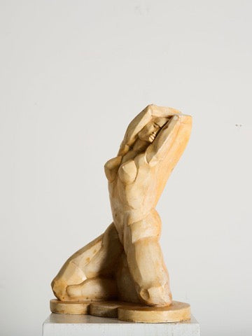 The Cubist Plaster Study by Ancien et Jolie reflects 1960s France with its abstract human figure kneeling with raised arms. Its simplified curves and smooth texture echo cubist style, and it stands on a small white base against a plain background.