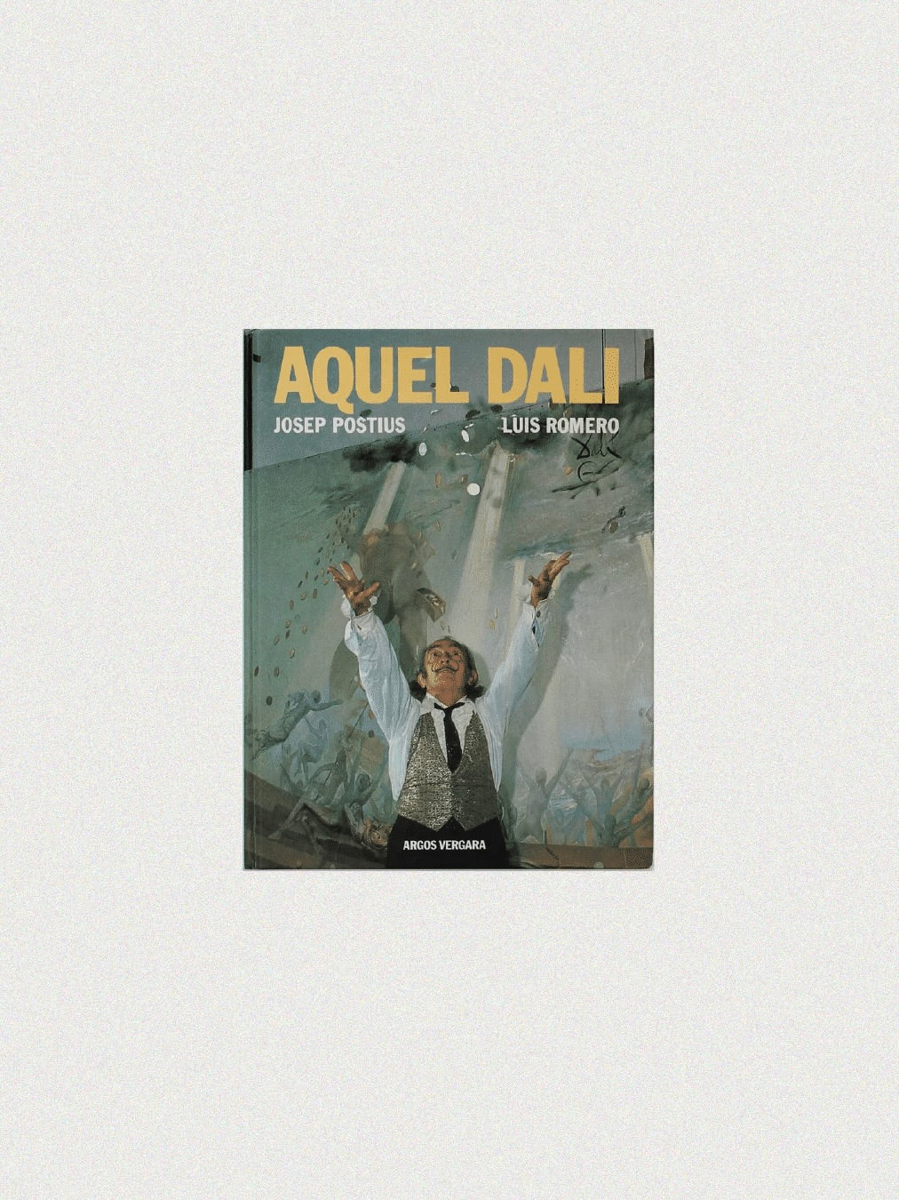 The Aquel Dali Book from Boga Avante Shop features a cover of Salvador Dalí with his iconic mustache and vest, tossing paintbrushes amid abstract shapes that capture his surrealist artistry.