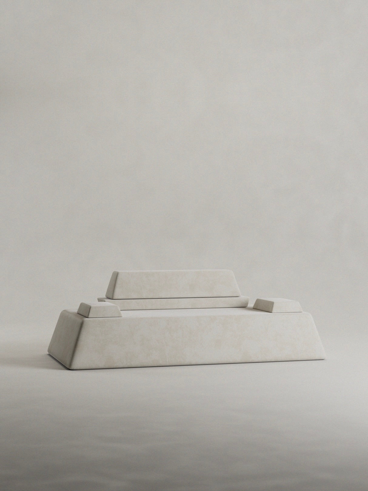 The 'Calakmul' Sofa by Siete Studio embodies the clean geometry of ancient civilizations with its minimalist design, featuring a white marble rectangular base and matching top against a light gray backdrop, echoing the serenity of a pyramid structure.