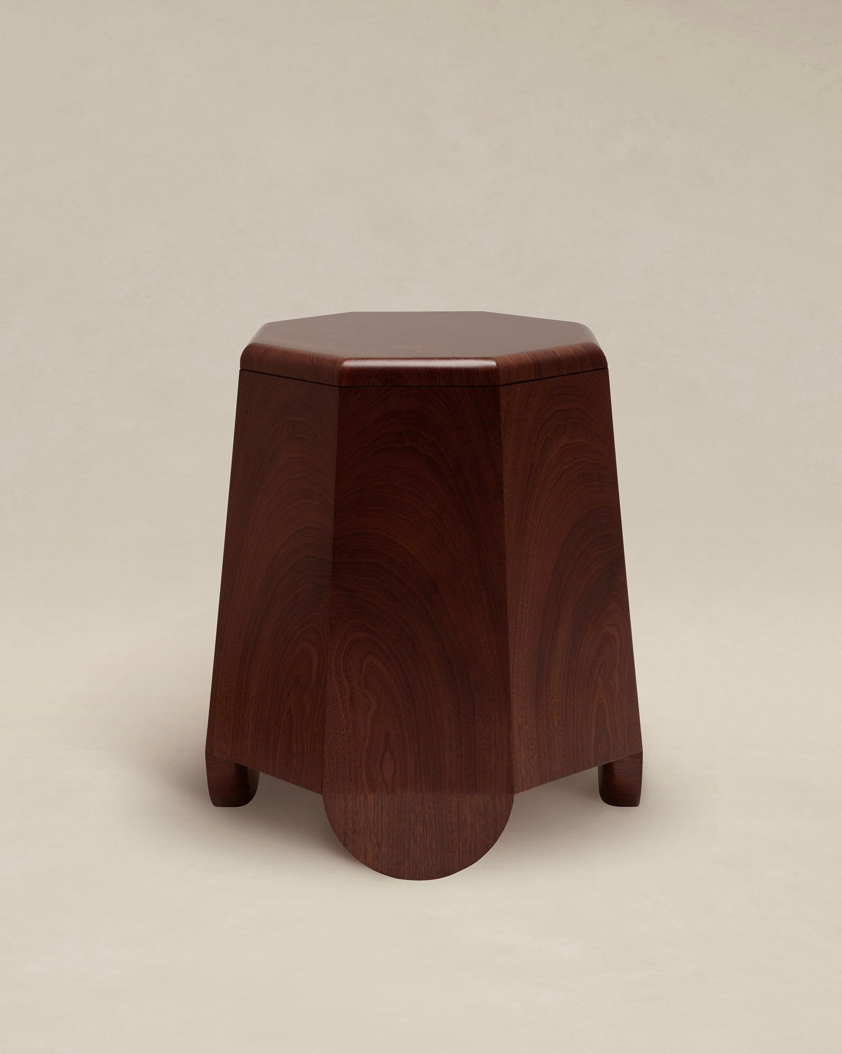 AÈDE Studios presents the Chatior Side Table, featuring a polished wooden design with an octagonal top and gently curved legs. The rich dark brown finish accentuates the natural grain patterns, evoking a sense of Byzantine architecture, while standing gracefully against a plain, light beige background.