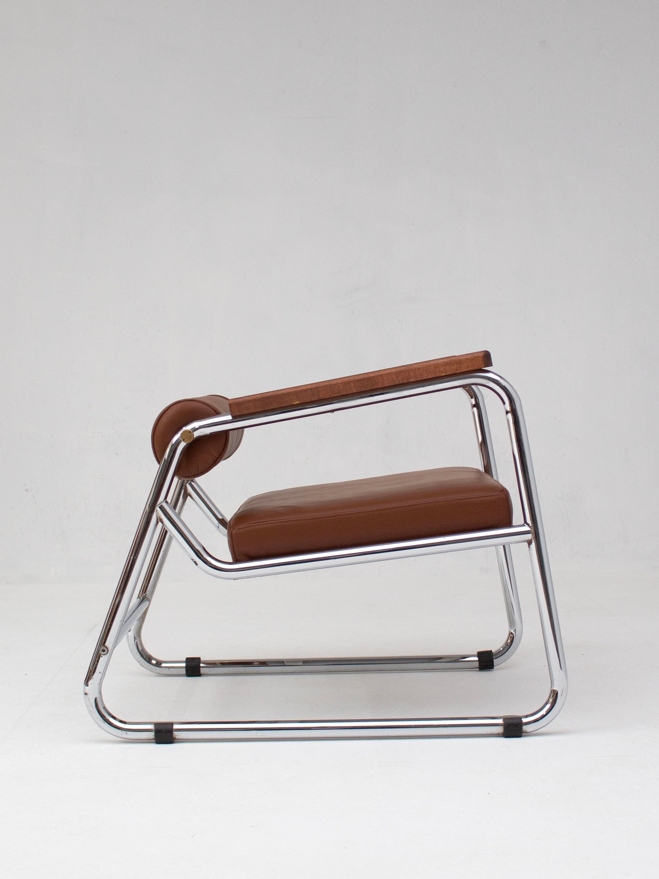WowIMeanWaw's Mid-Century Modern Lounge Chairs in Chrome feature a sleek, rectangular chrome-metal frame with brown leather upholstery. The minimalist design is enhanced by optional wooden armrests, exuding a mid-century modern aesthetic against a plain white background.