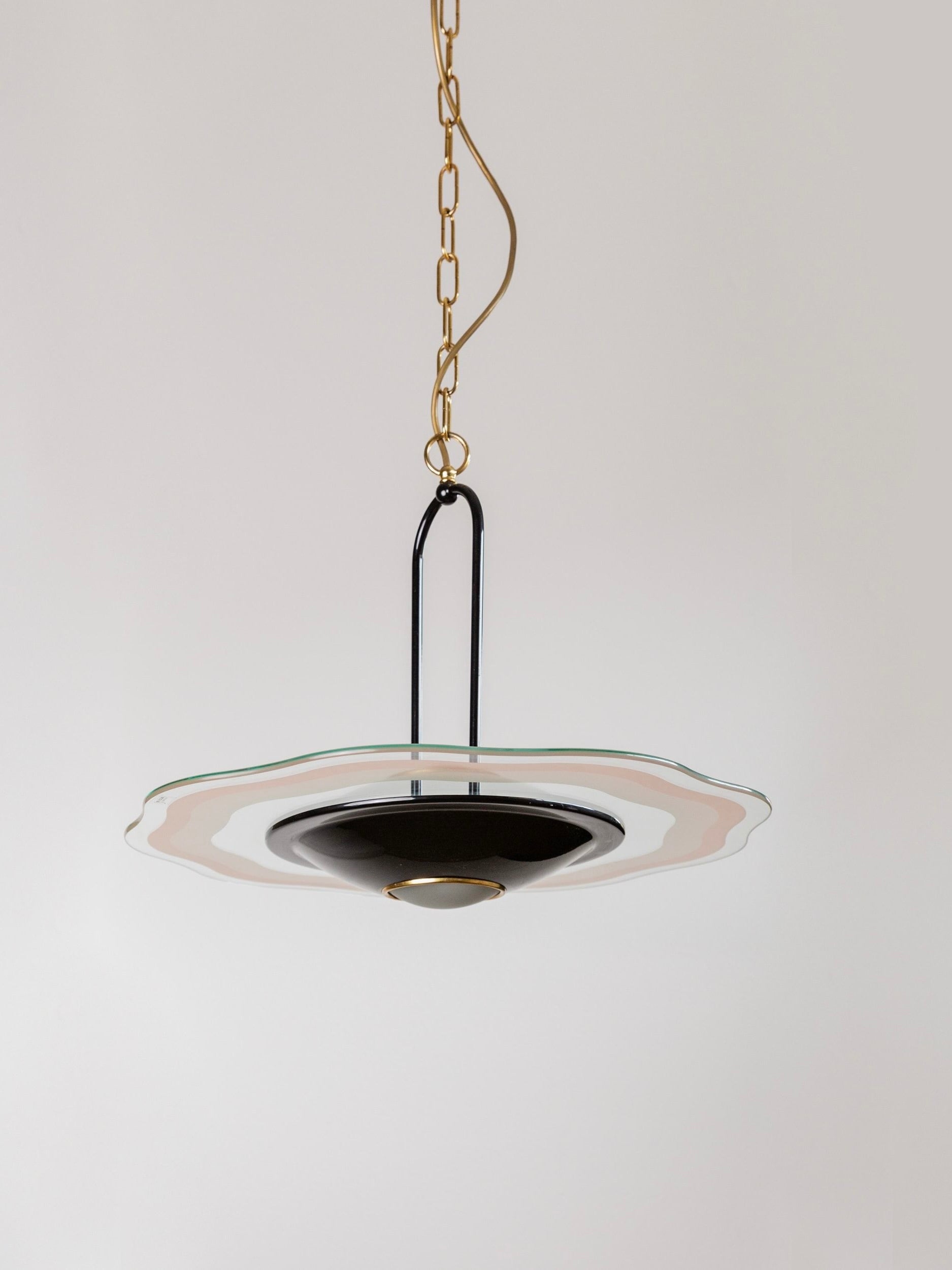 The Bottega Jacobs' Vintage Ceiling Lamp - 1980s Murano Glass features a central black fixture and a wavy, translucent Murano glass shade. Suspended from the ceiling by a gold chain, its design evokes mid-century aesthetics, elegantly set against a plain white background.