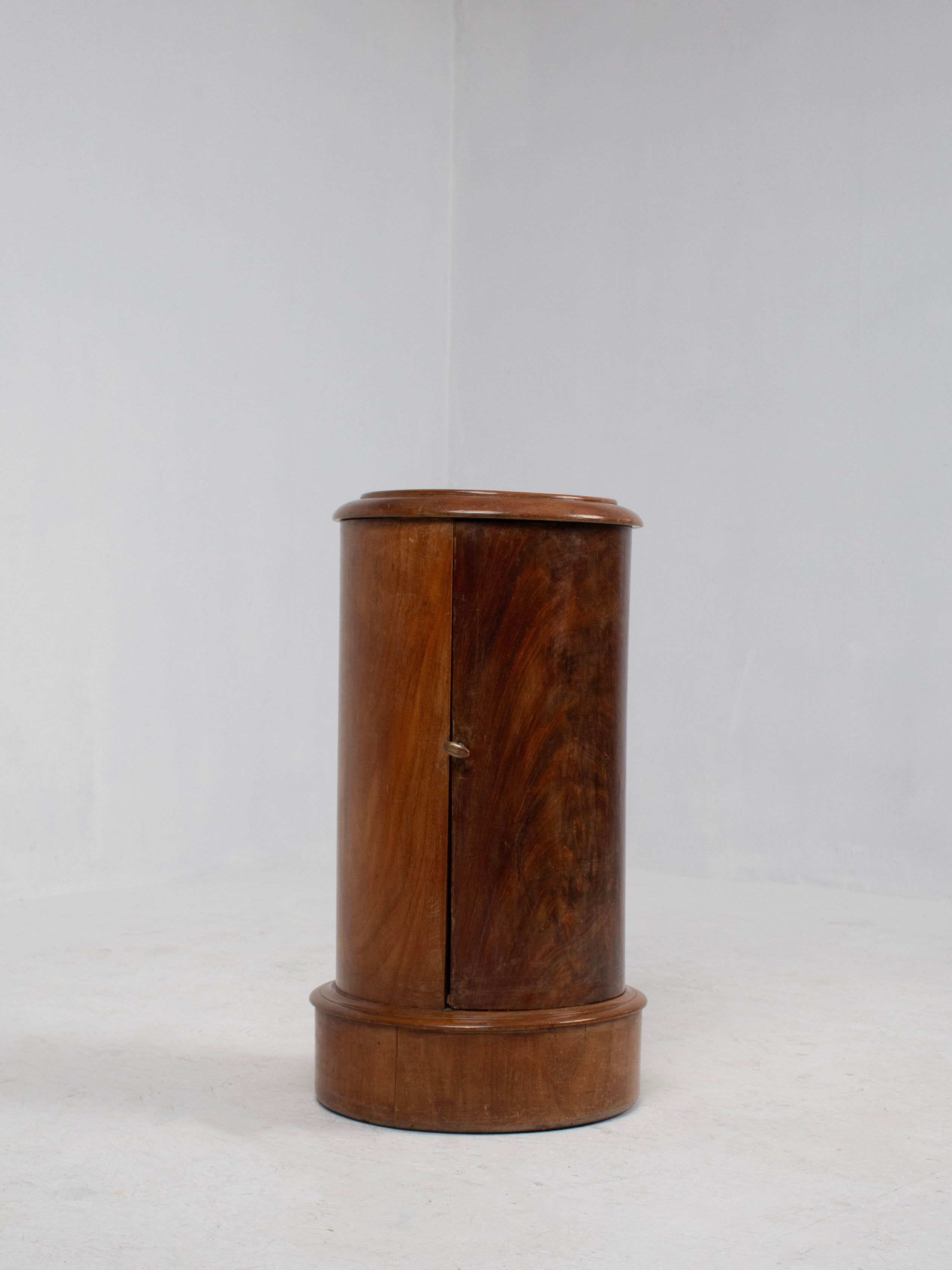 The WowIMeanWaw French Art Deco Nightstand is a cylindrical mahogany cabinet featuring a smooth finish and curved front door. Its 20th-century craftsmanship includes a slightly raised base and flat top, evoking classic French design against a plain white backdrop.