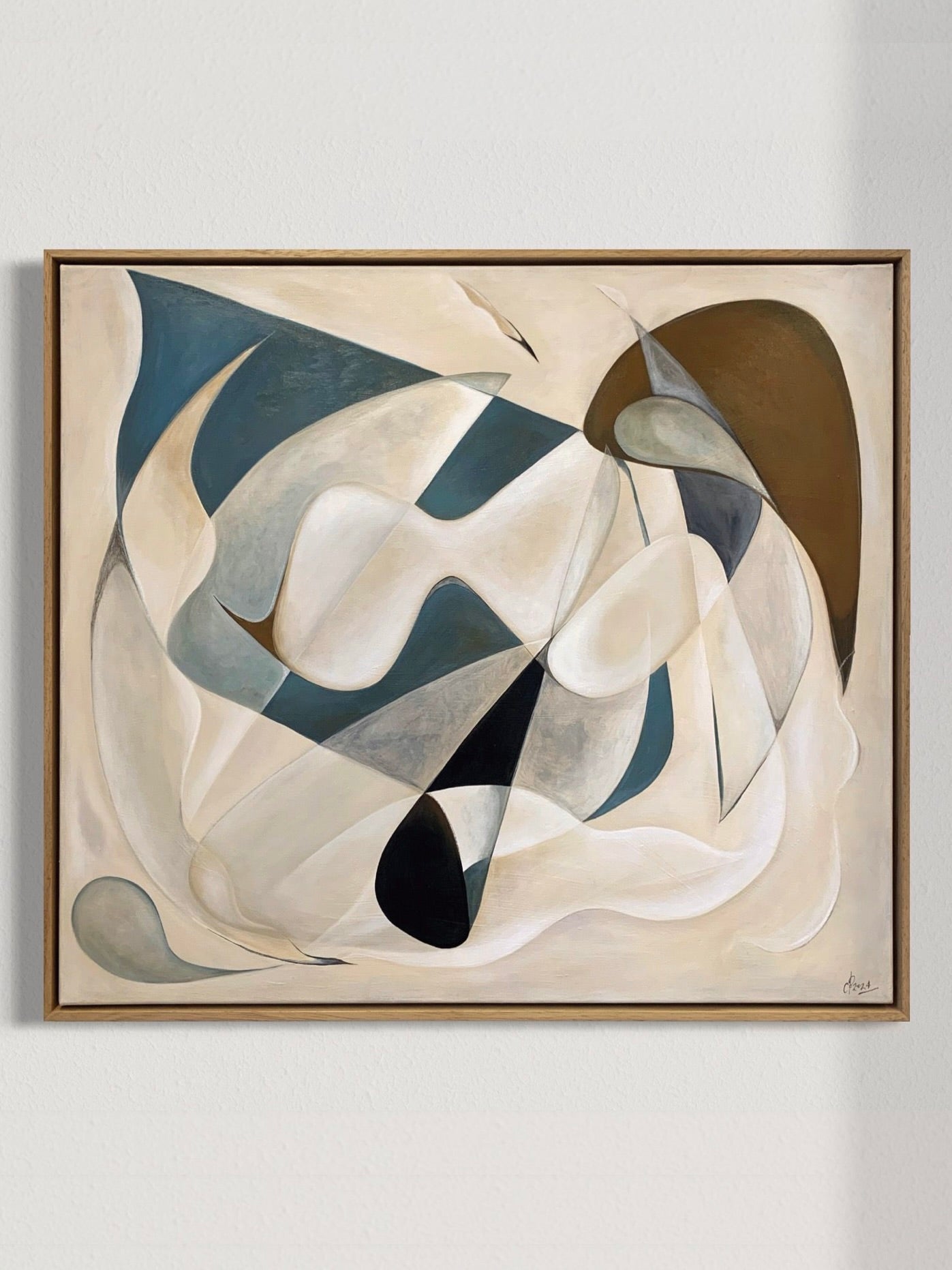 The painting titled "Fragments of The Unseen, 2024" by Cate Adriana showcases abstract acrylic artistry with a swirl of geometric shapes in blue, brown, and gray. These dynamic forms gracefully flow across a light cream background reminiscent of pastels, adding movement and depth. Elegantly framed on a plain wall, it creates a striking visual impact.