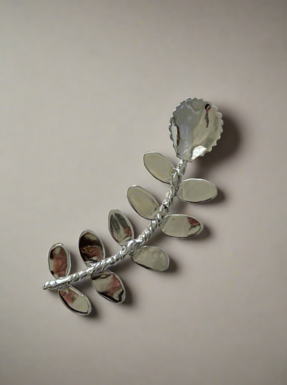 Corali Babette Compote Spoon, artistically handcrafted into a floral shape with a detailed stem and petals, displayed against a plain white background.