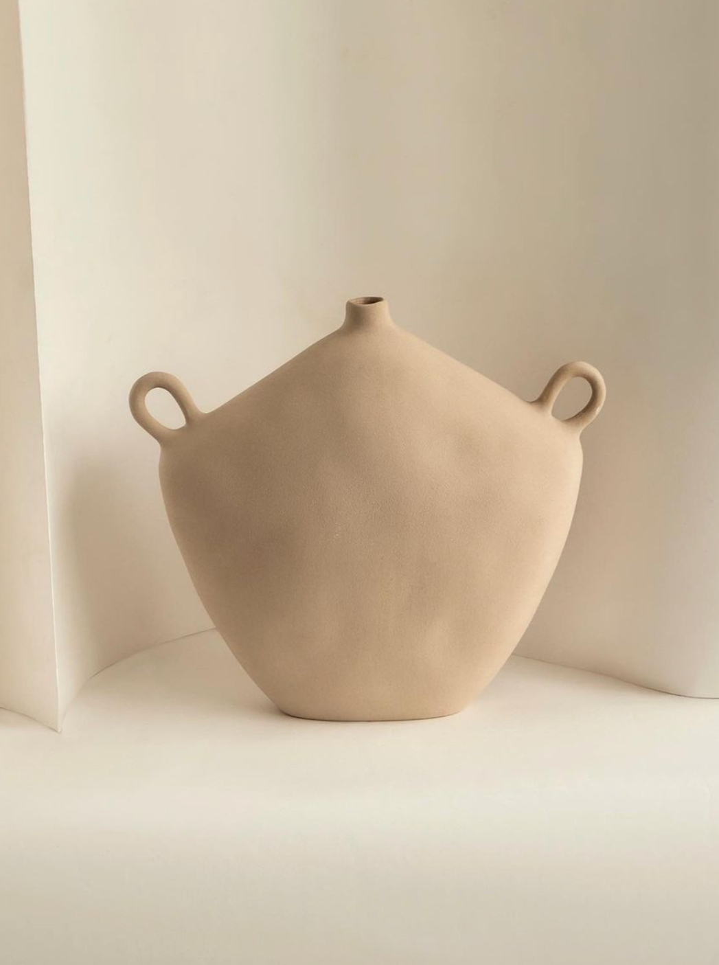 A Maria Vessel - Oat ceramic teapot with a textured matte glaze and a unique round body, photographed against a soft white background by Project 213A.