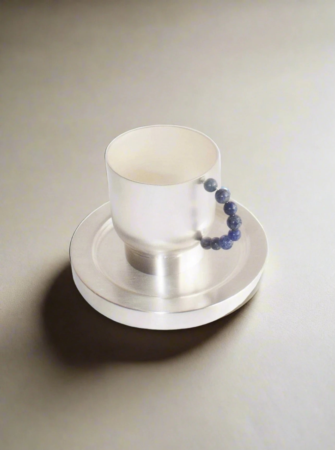 Close-up of elegant Perlina cup and piattino set, perfect for serving coffee or tea