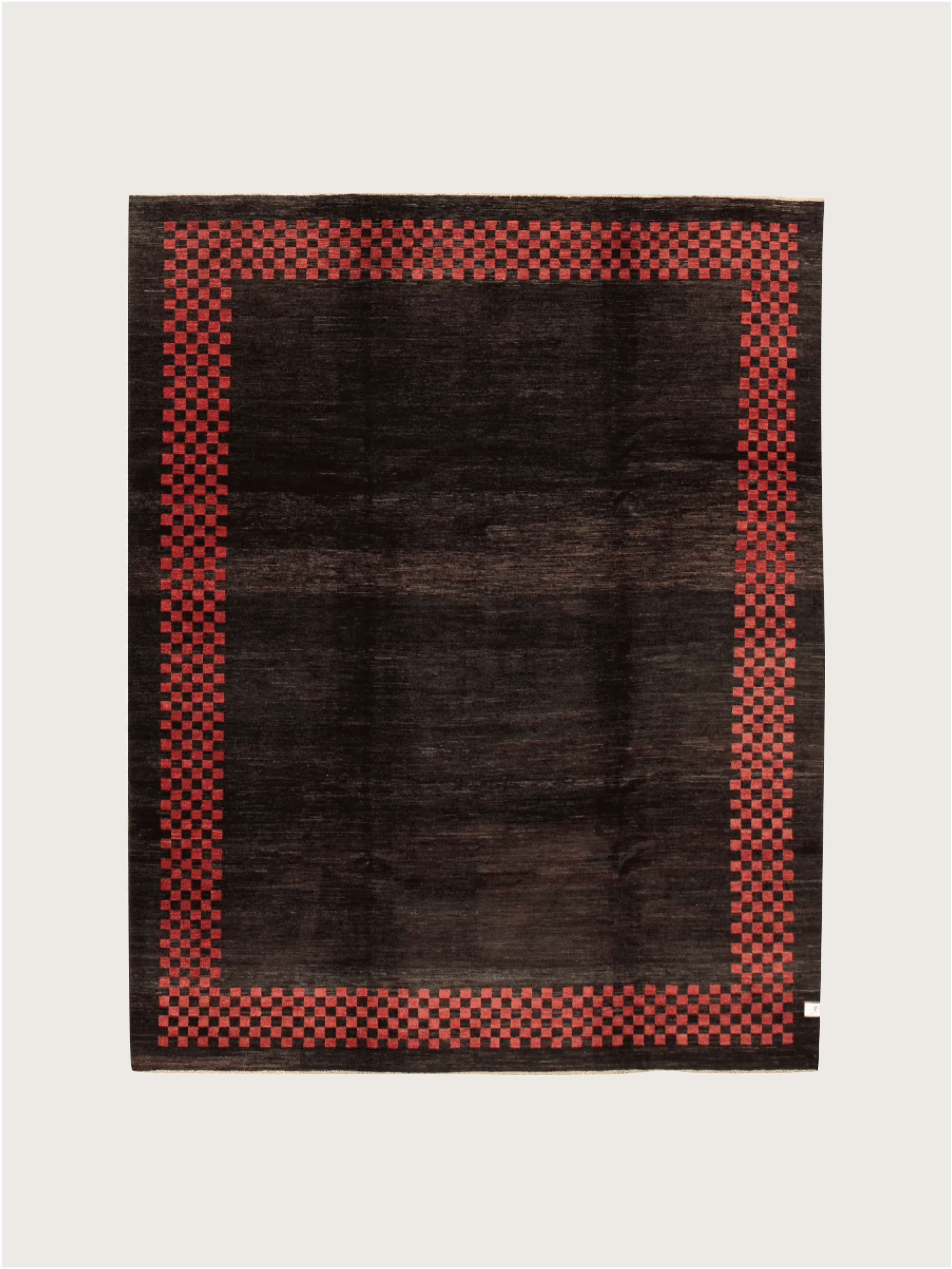 The Ziegler Rug in Obsidian by catalog:three features a large rectangular design with a dark brown center, a red checkered border, and measures 247 x 277 cm.