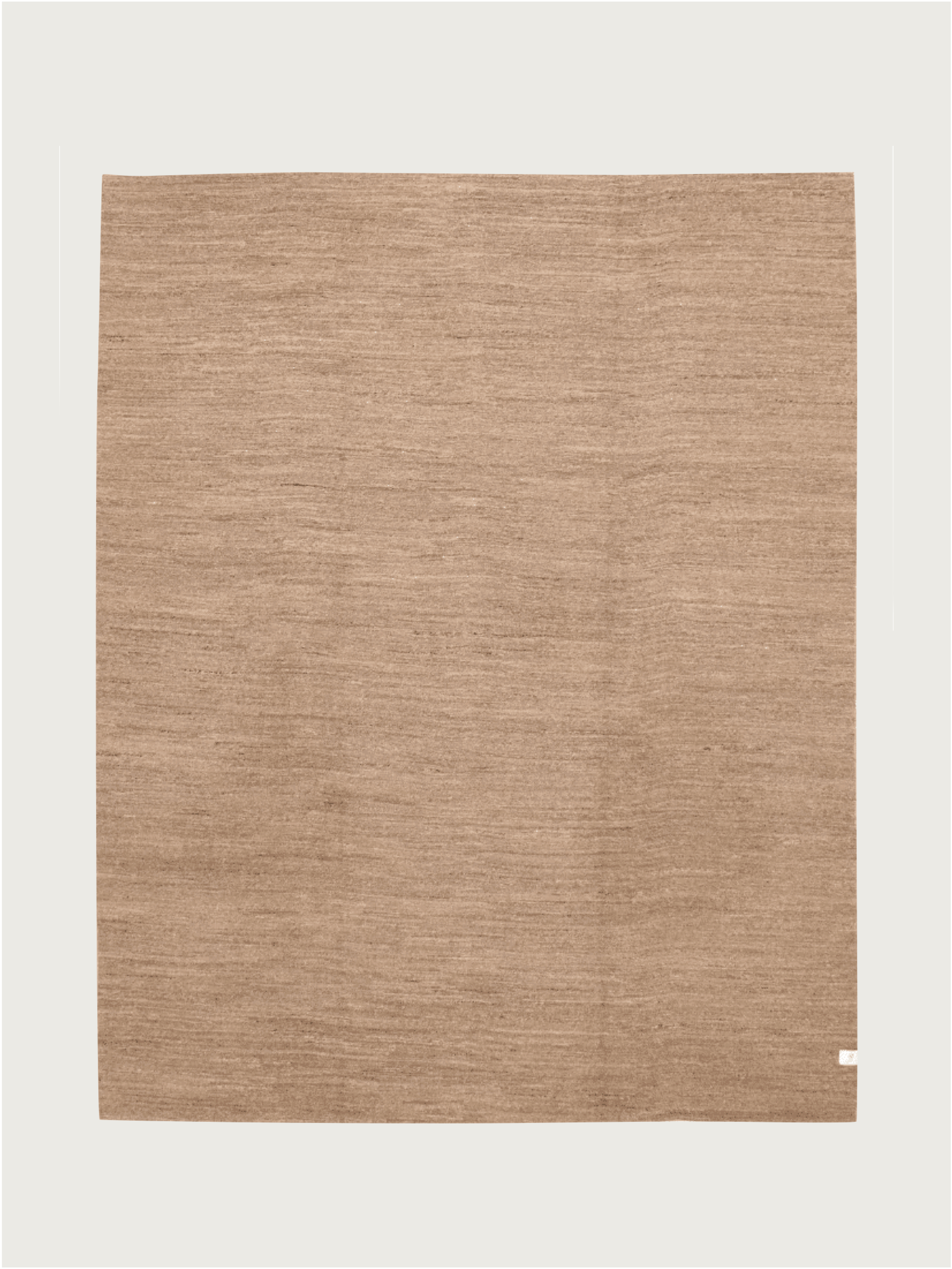 The Flatweave Rug in Sandalwood by catalog:three is a large, square rug (238 x 300 cm) with a subtle texture and minimal design. Hand-woven to look like natural fibers, it has a small tag in the bottom right corner against a plain white backdrop.