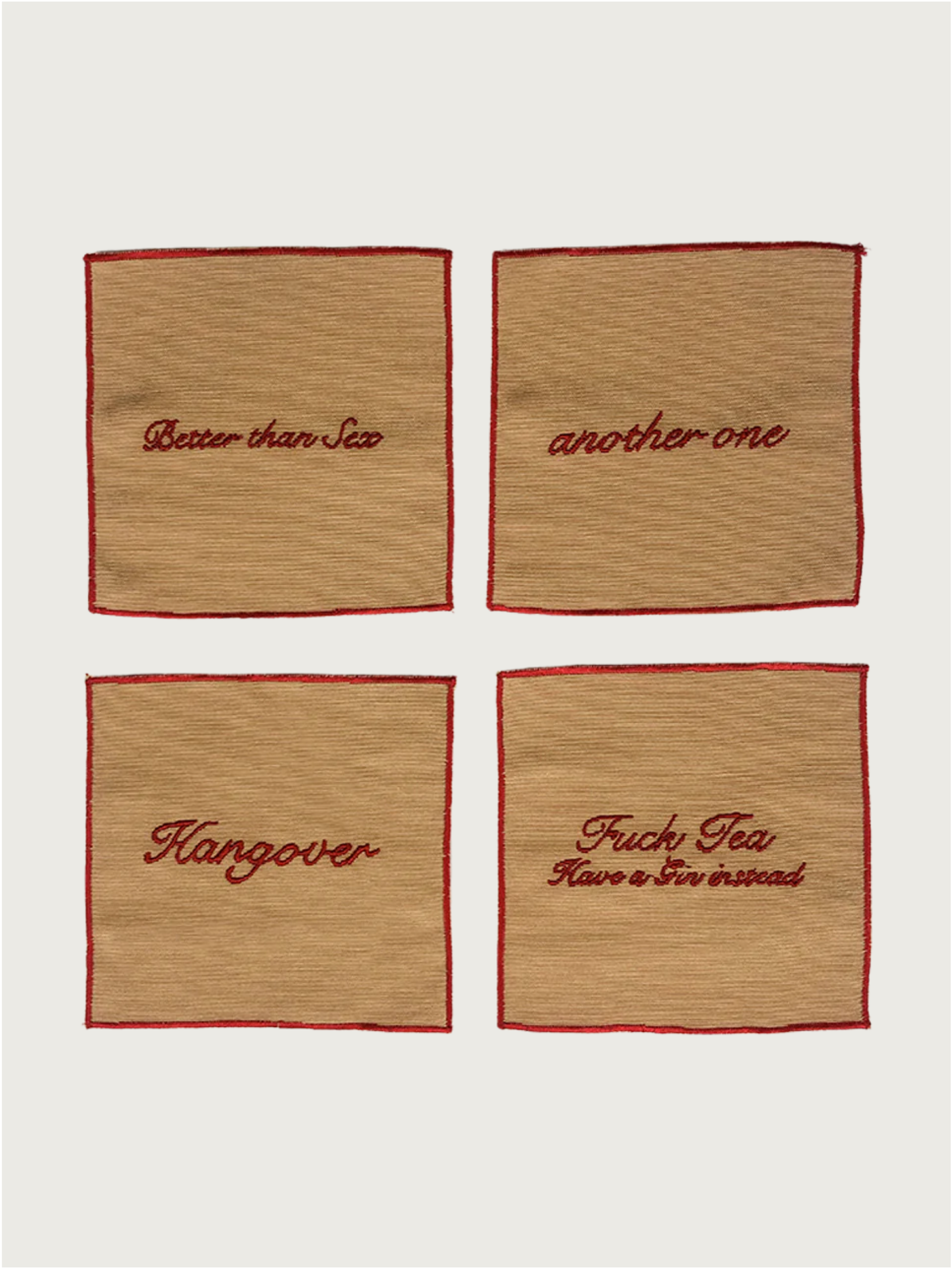 Musae Studio’s Set of 4 Cocktail Napkins features eco-friendly tan napkins with red trim, each embroidered with cheeky phrases, and made from upcycled cotton.