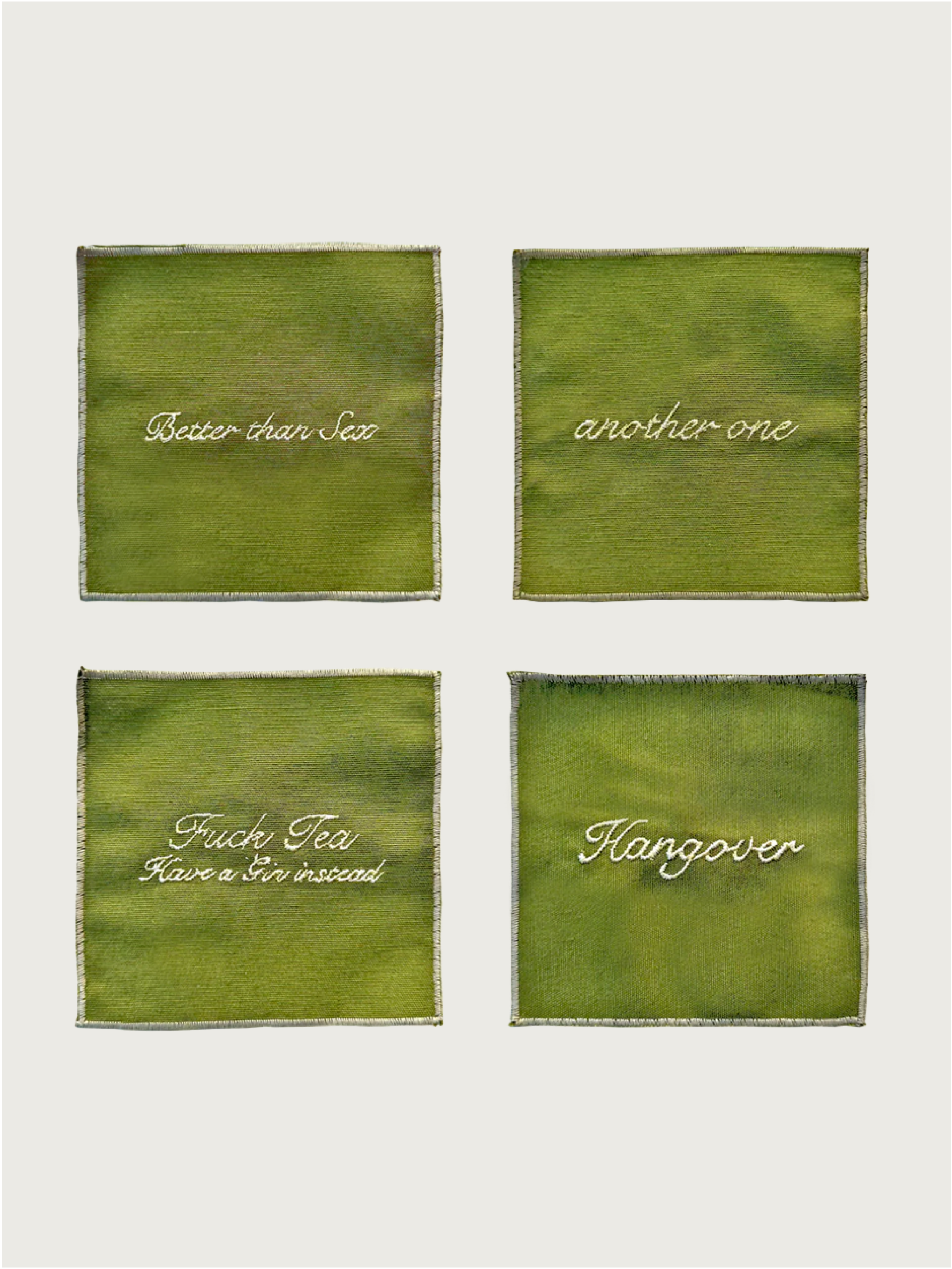The Musae Studio Set of 4 green upcycled cotton cocktail napkins features white embroidered text: “Better than Sex,” “another one,” “Fuck Tea Have a Gin instead,” and “Hangover”—a fun touch for your cocktail accessories.