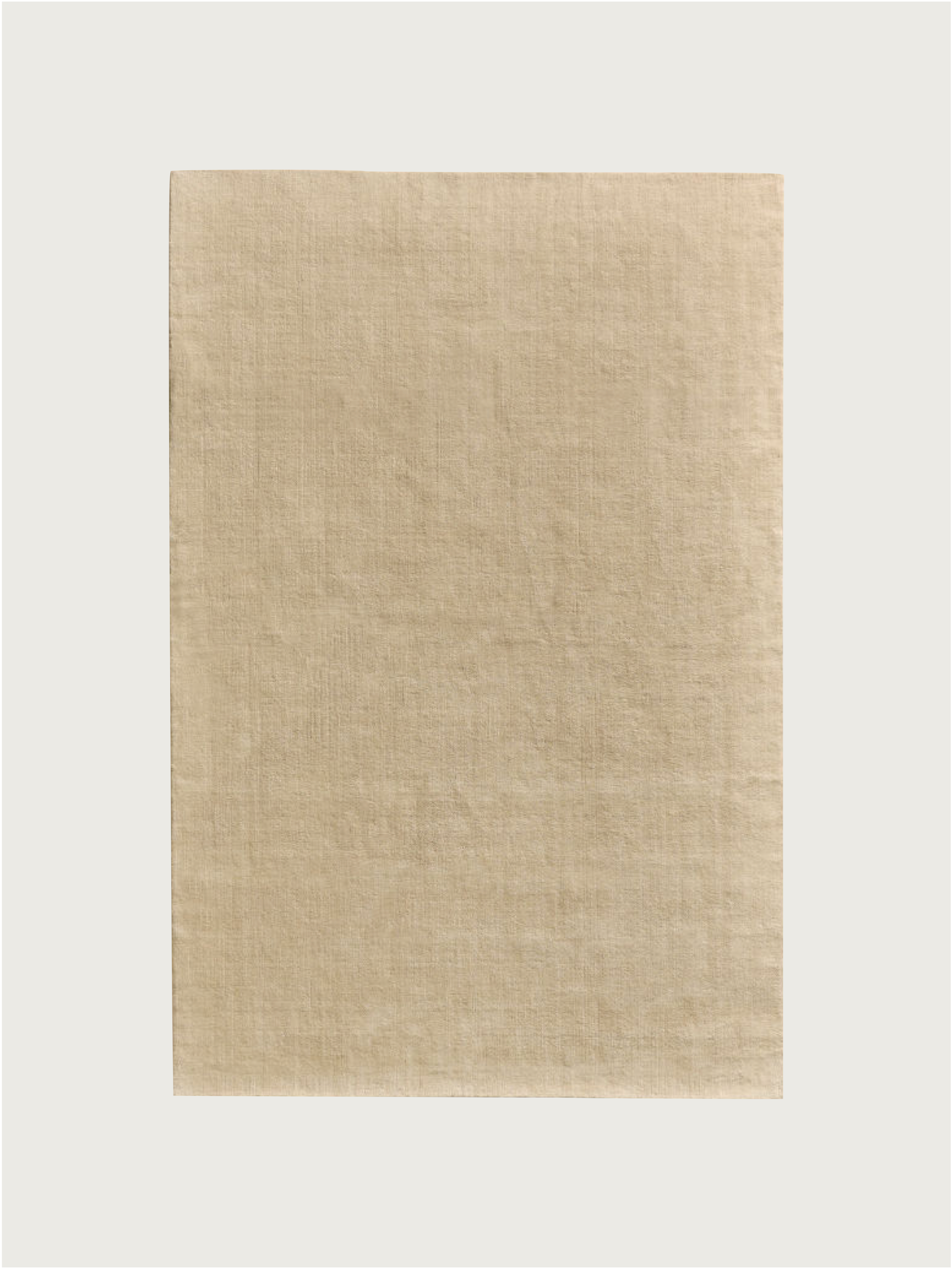 A rectangular Hand-woven Rug in New Zealand Wool, Beige Sand by MOST is centered on a white background, its subtle texture evoking the natural fibers and premium quality of this elegant piece.