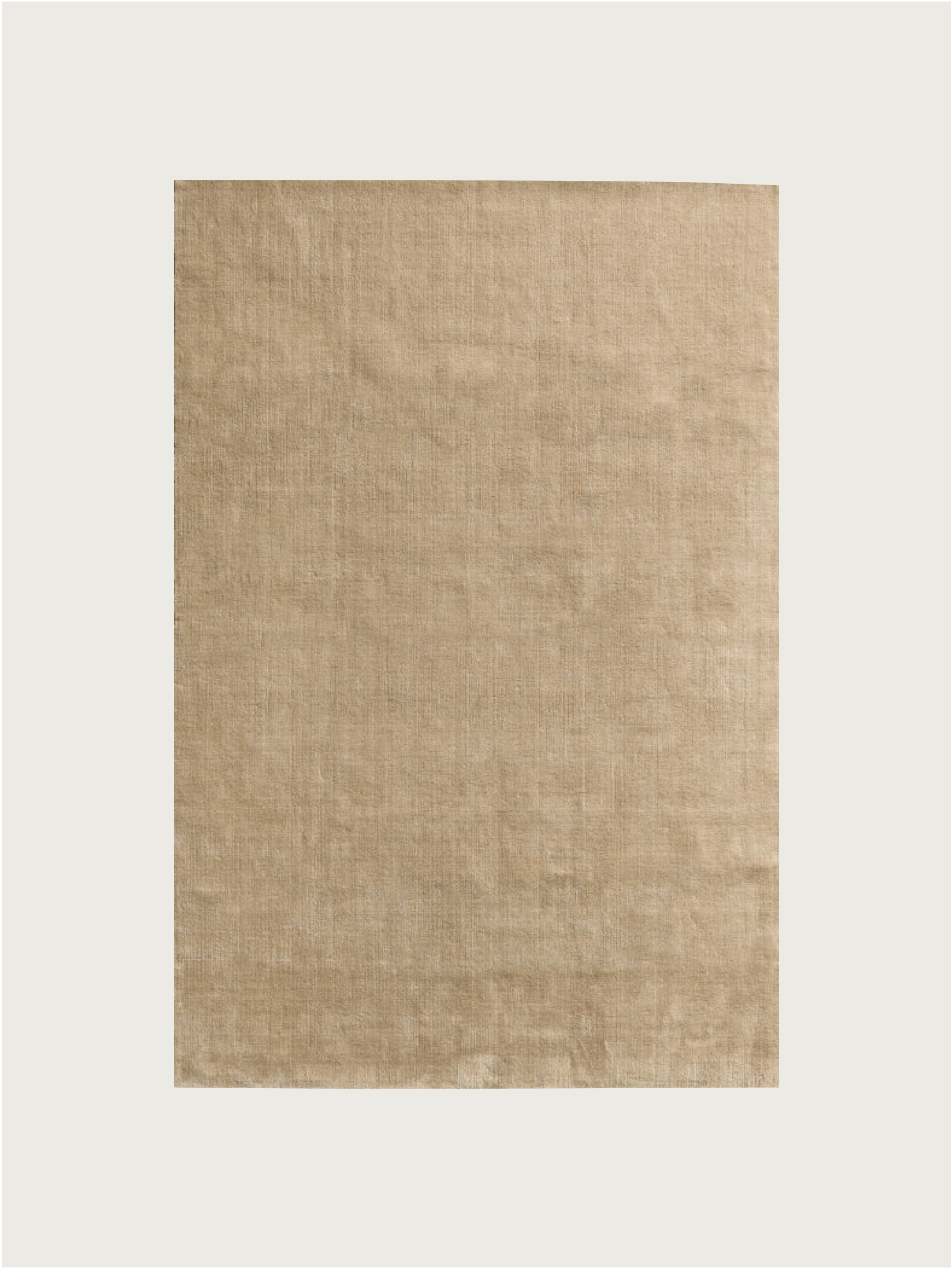 The MOST 'Châtaigne' hand-woven rug, crafted from New Zealand wool in India, features a large rectangular beige design with a subtle textured finish, shown on a plain white background.