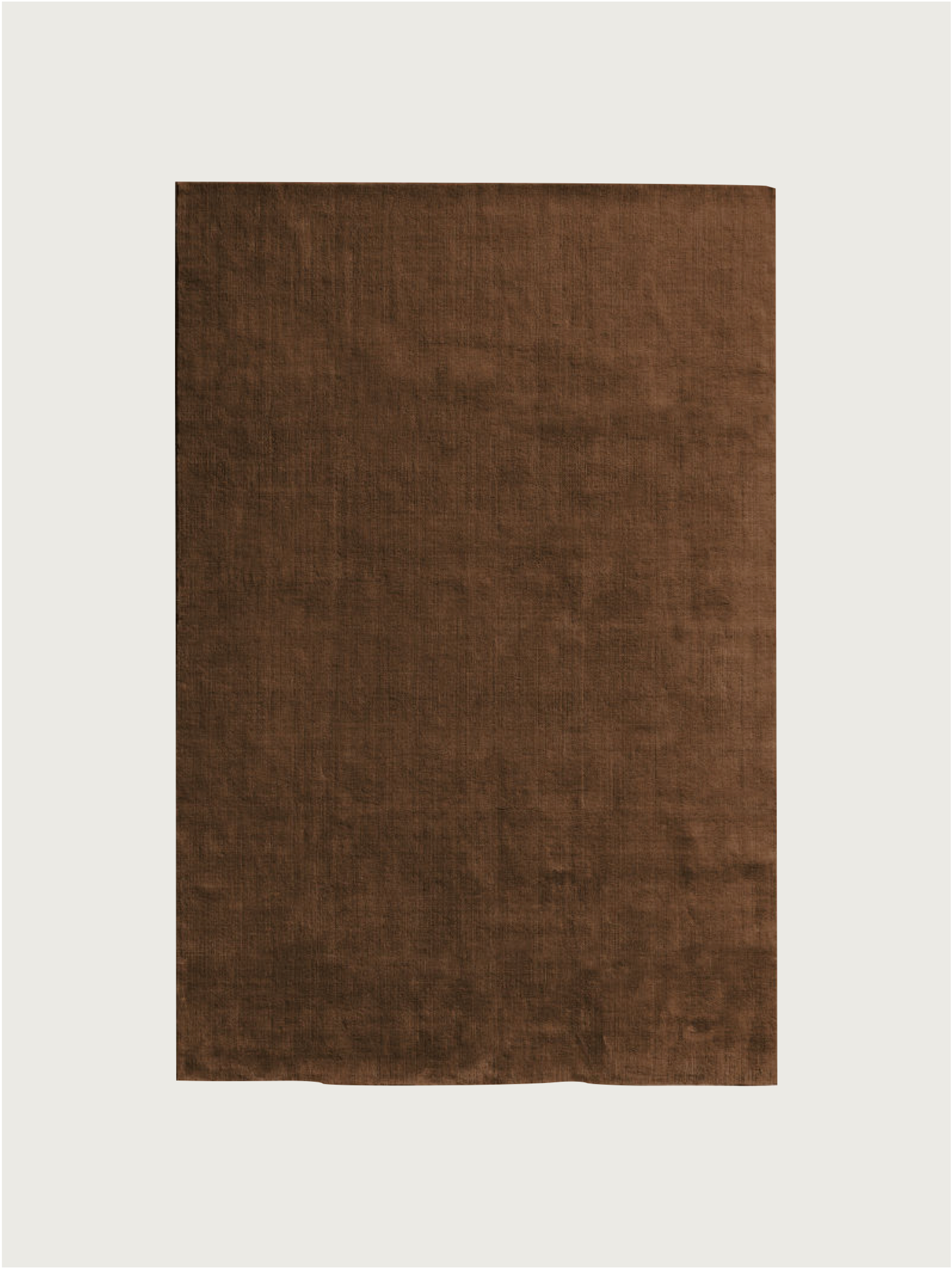 The MOST Hand-woven Rug in New Zealand Wool, Cacao Brown, features a rectangular shape, solid brown color, soft texture, and high wool density. Displayed on a plain white background.