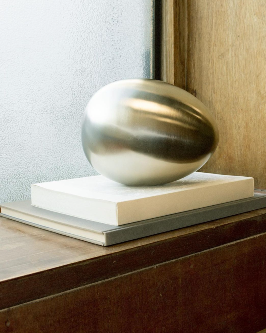 Brushed Steel Egg Sculpture with Abstract Design and Smooth Texture