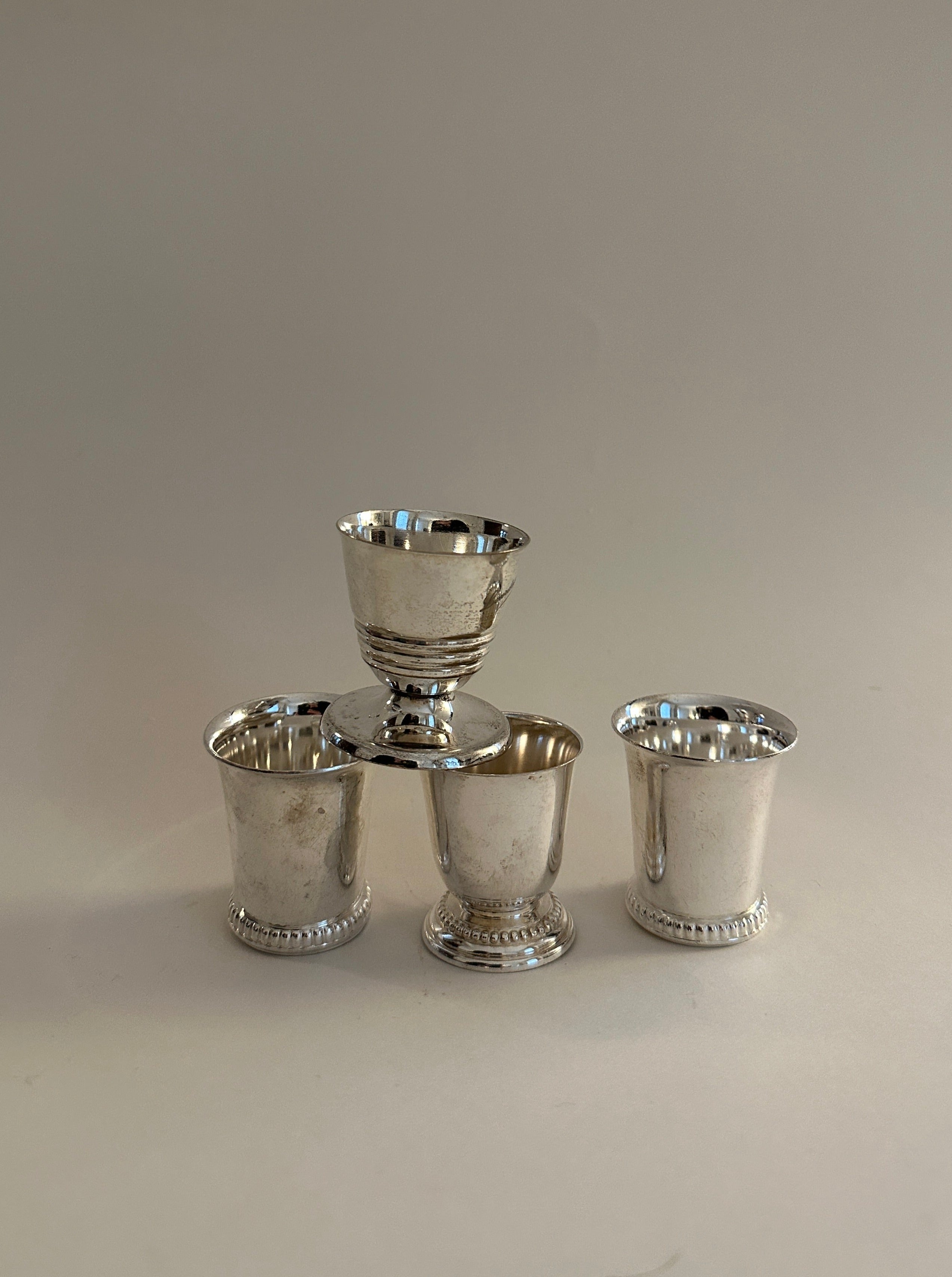 Shiny silver plated egg cups in a set of four, perfect for serving breakfast