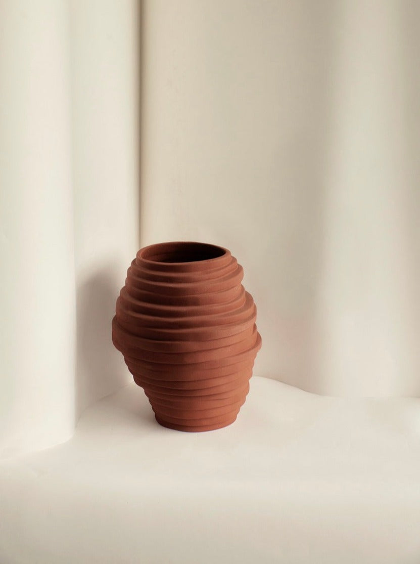 Alfonso Vase standing tall on a marble countertop, showcasing its intricate patterns and elegant curves