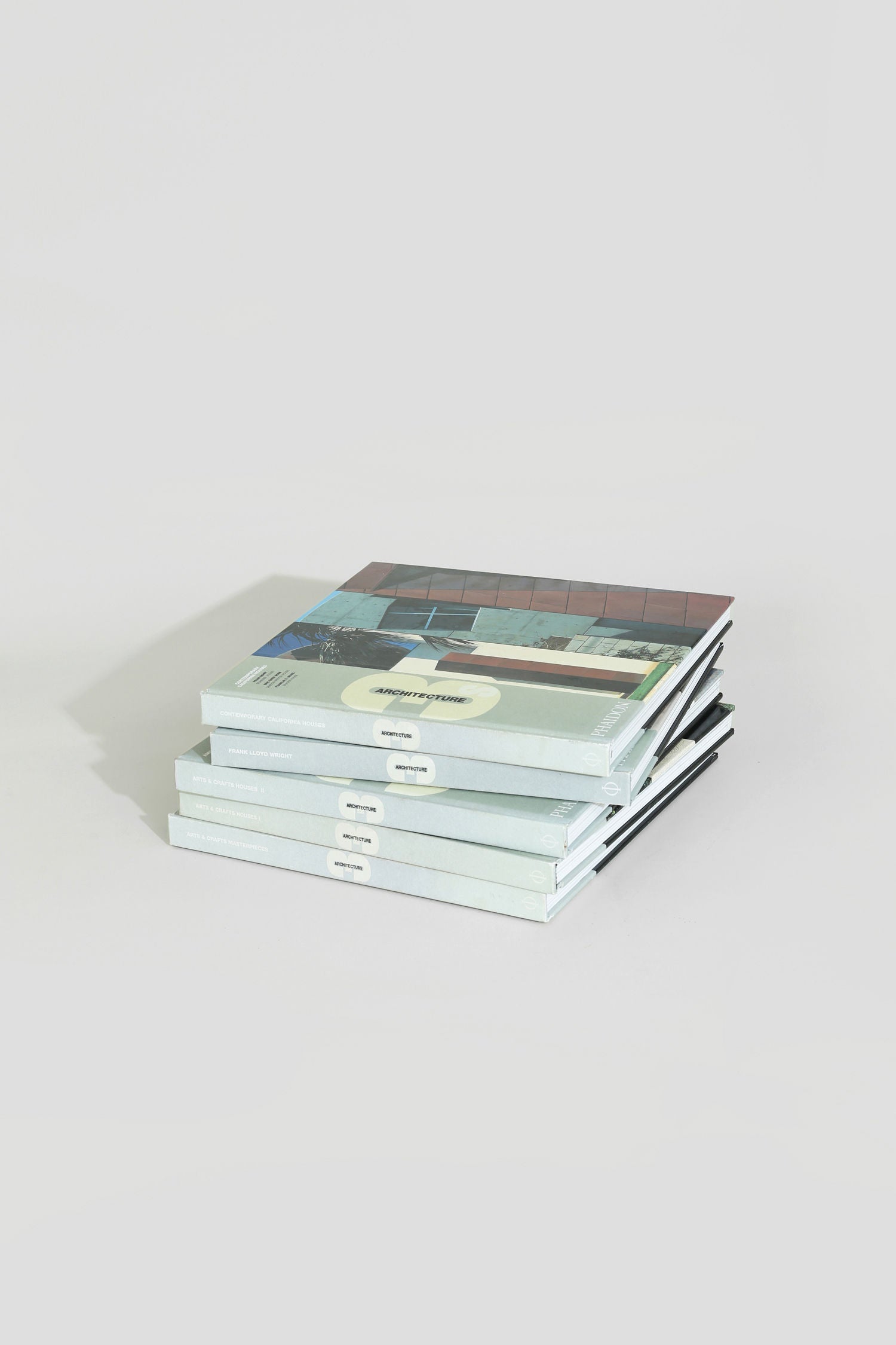 The Villa Architecture Book Series - Set of 5 features modern, minimalist covers and is neatly arranged on a light gray surface, ideal as a stylish architecture coffee table book display against a white background.