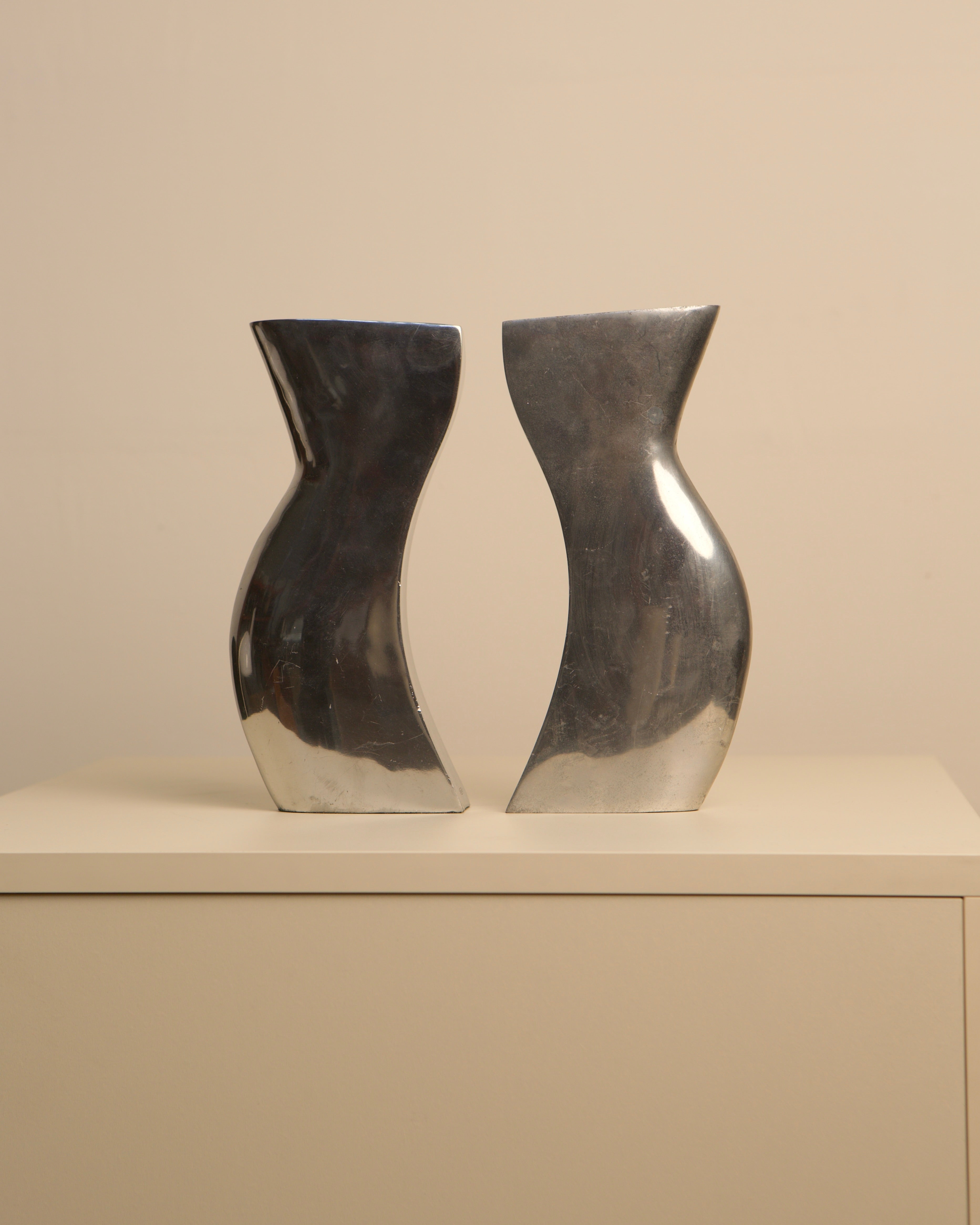 Pair of Italian cast aluminum Dance vases with curved silhouettes