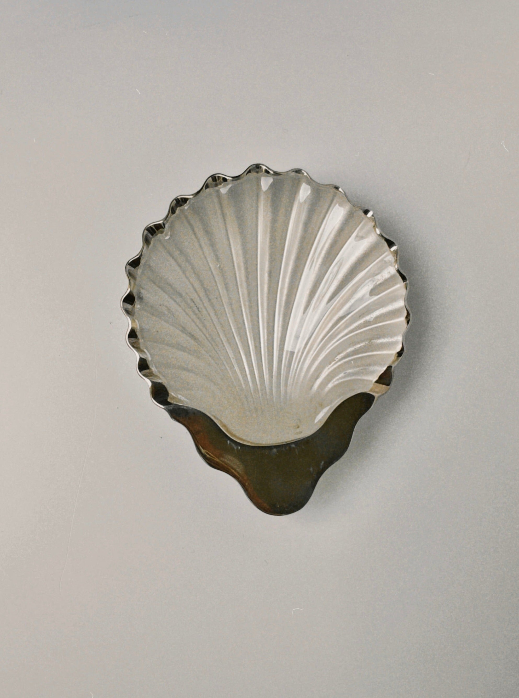 Beautiful silver shell shaped dish with intricate detailing and polished finish