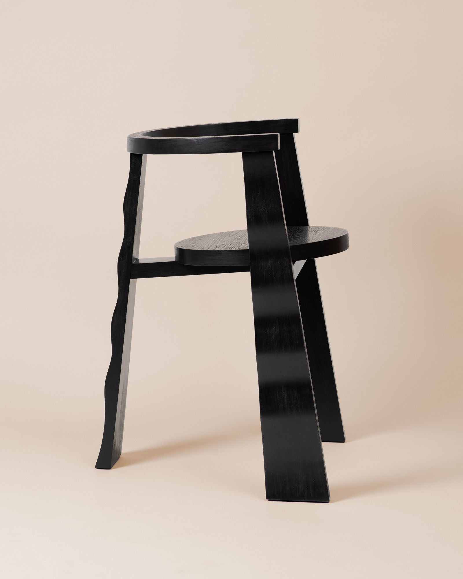 Black wooden Puro chair with curved backrest and round seat by Elina Ulvio