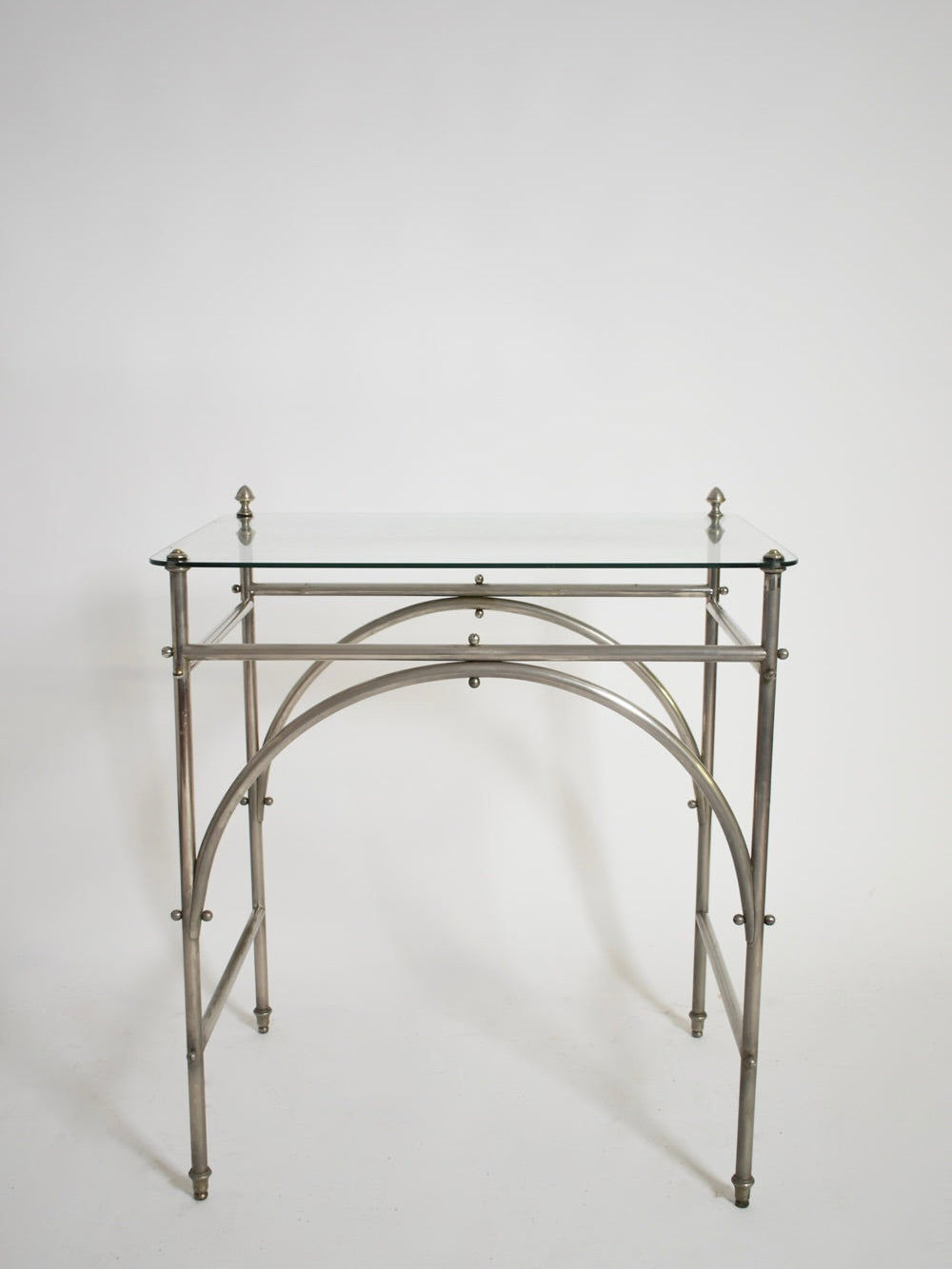The Tubular Chrome Iron and Glass Table, 1920s by Barracuda Interiors features a minimalist chrome frame, rectangular glass top, and arched metal supports, shown against a plain white background.