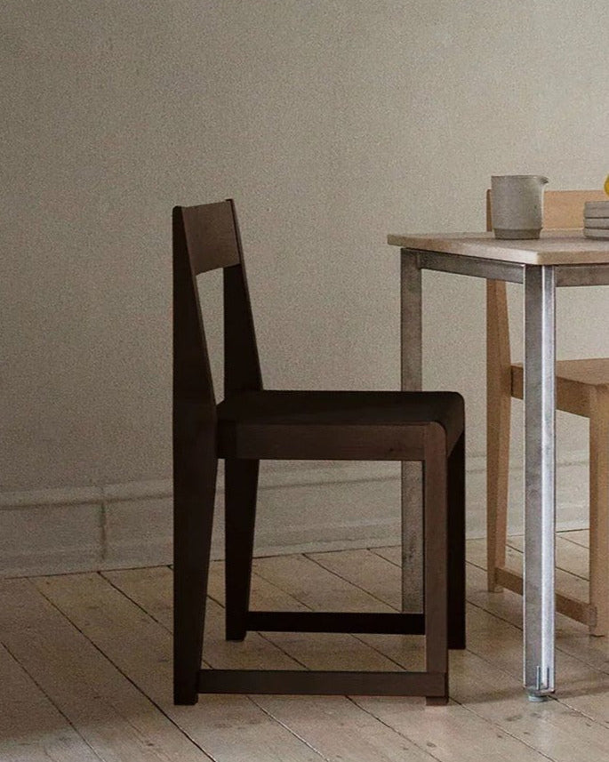 FRAMA Chair 01 dark birch wood dining chair in minimalist interior