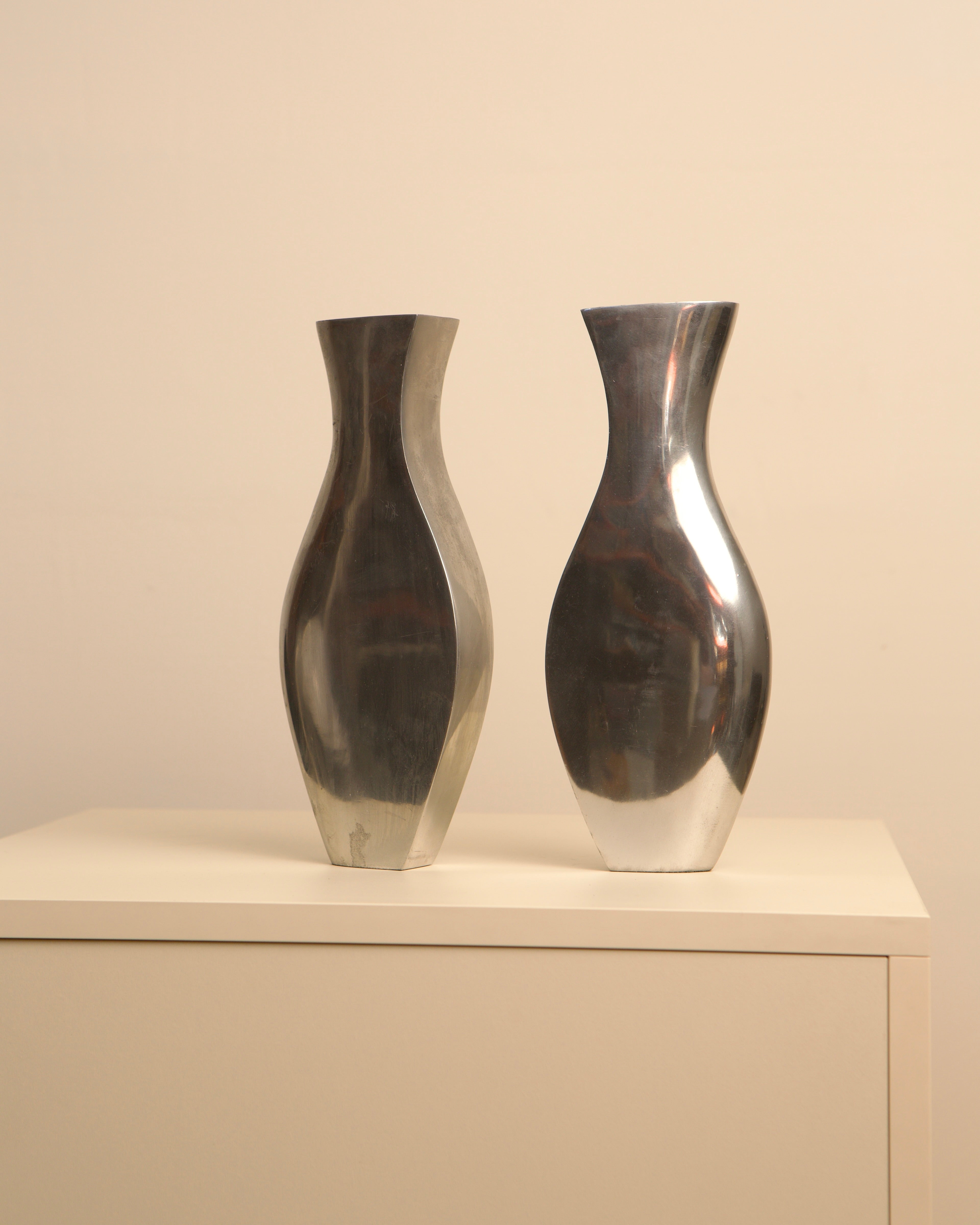 Pair of Italian aluminum Dame vases with curved silhouettes, 1980s