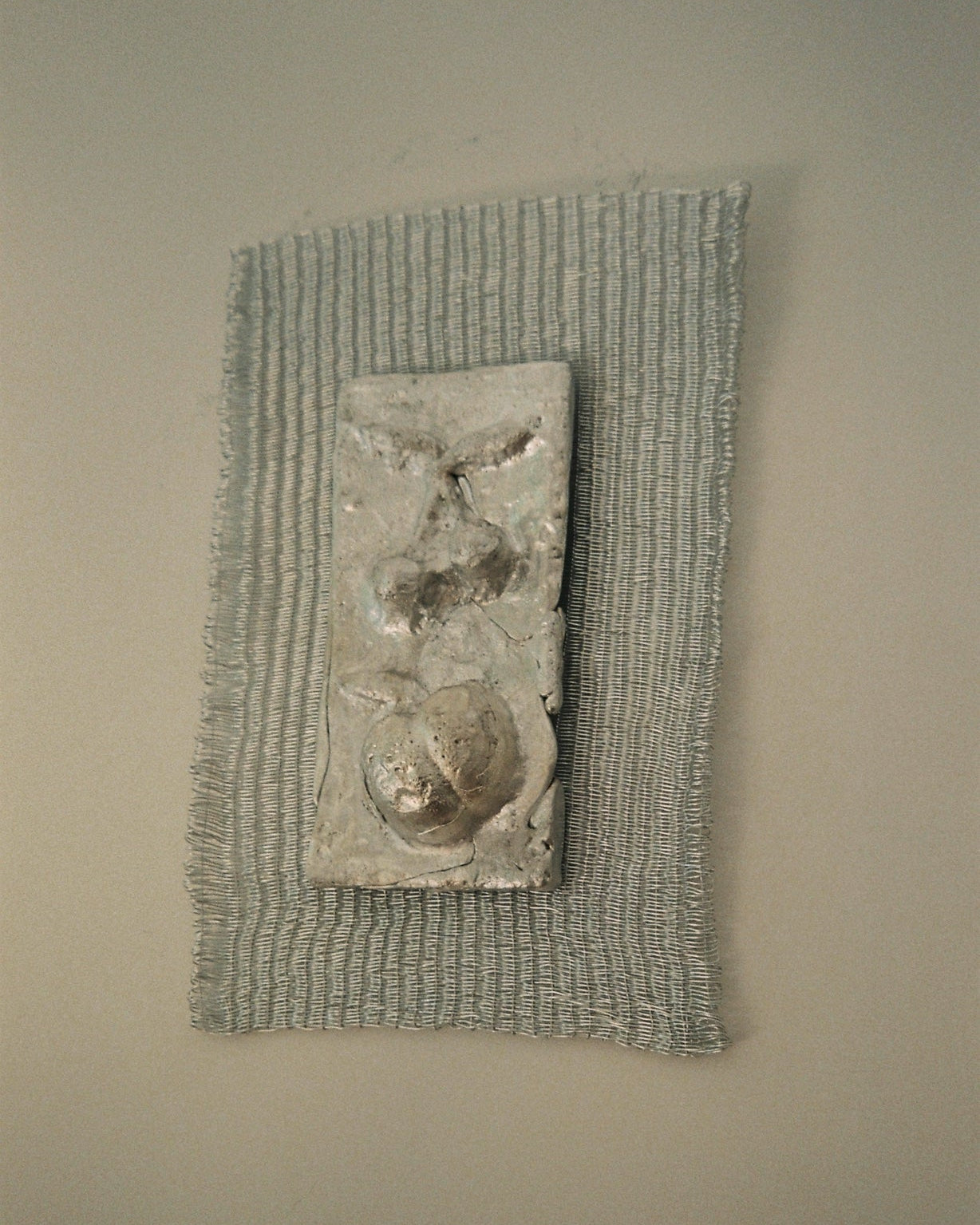 Contemporary textured wall sculpture with organic forms in neutral tones