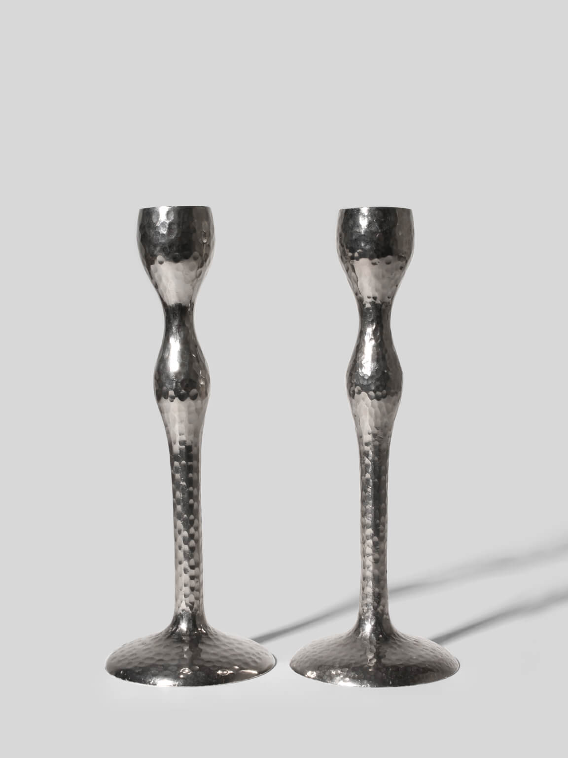 Pair Of Tall Textured Mirror Metal Candlesticks by Vintage Stories | The Oblist