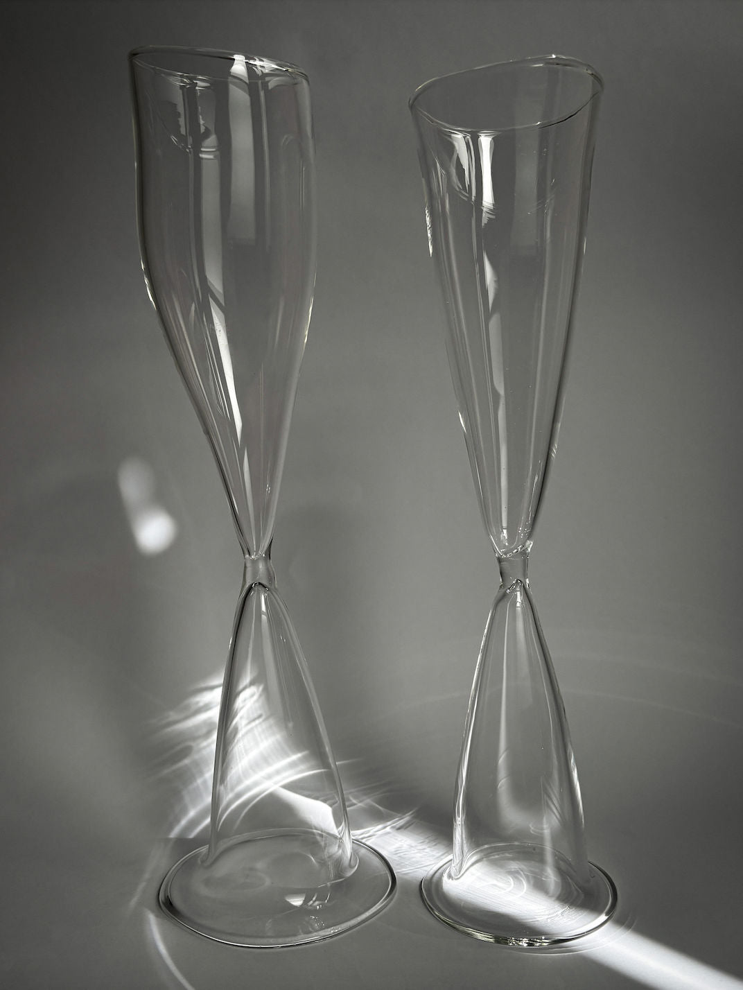 Two elegant twisted stem champagne flutes in clear crystal glass