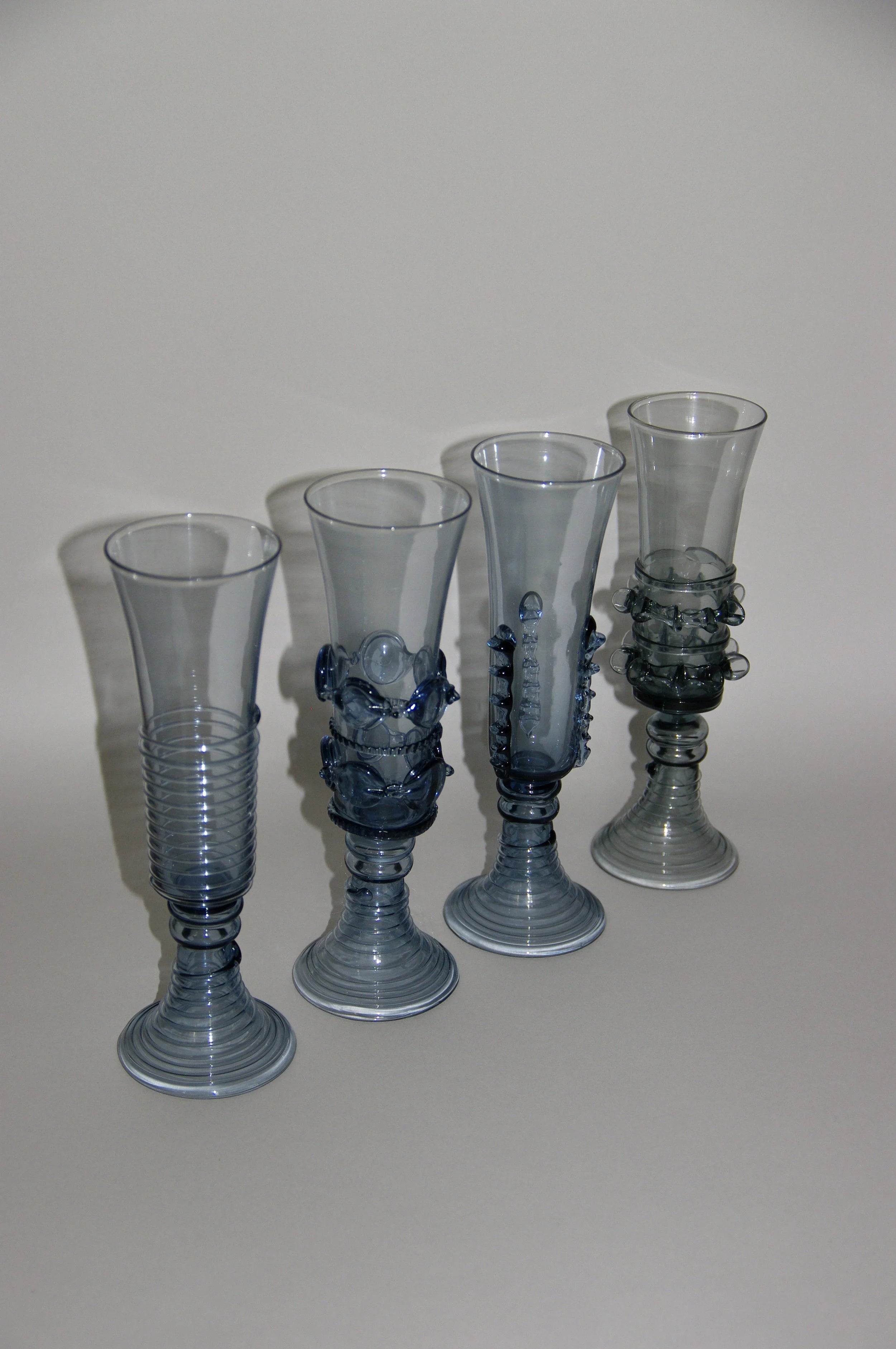 Mouthblown Champagne Coupe & Flute - Set of Four — side view showing blue glass design