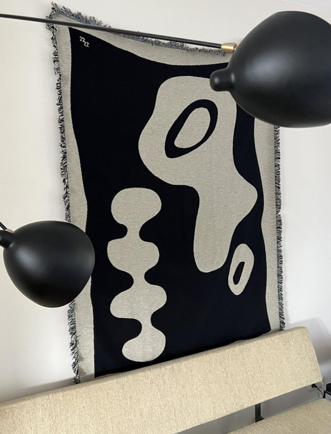 Teuru jacquard throw with black and cream abstract pattern