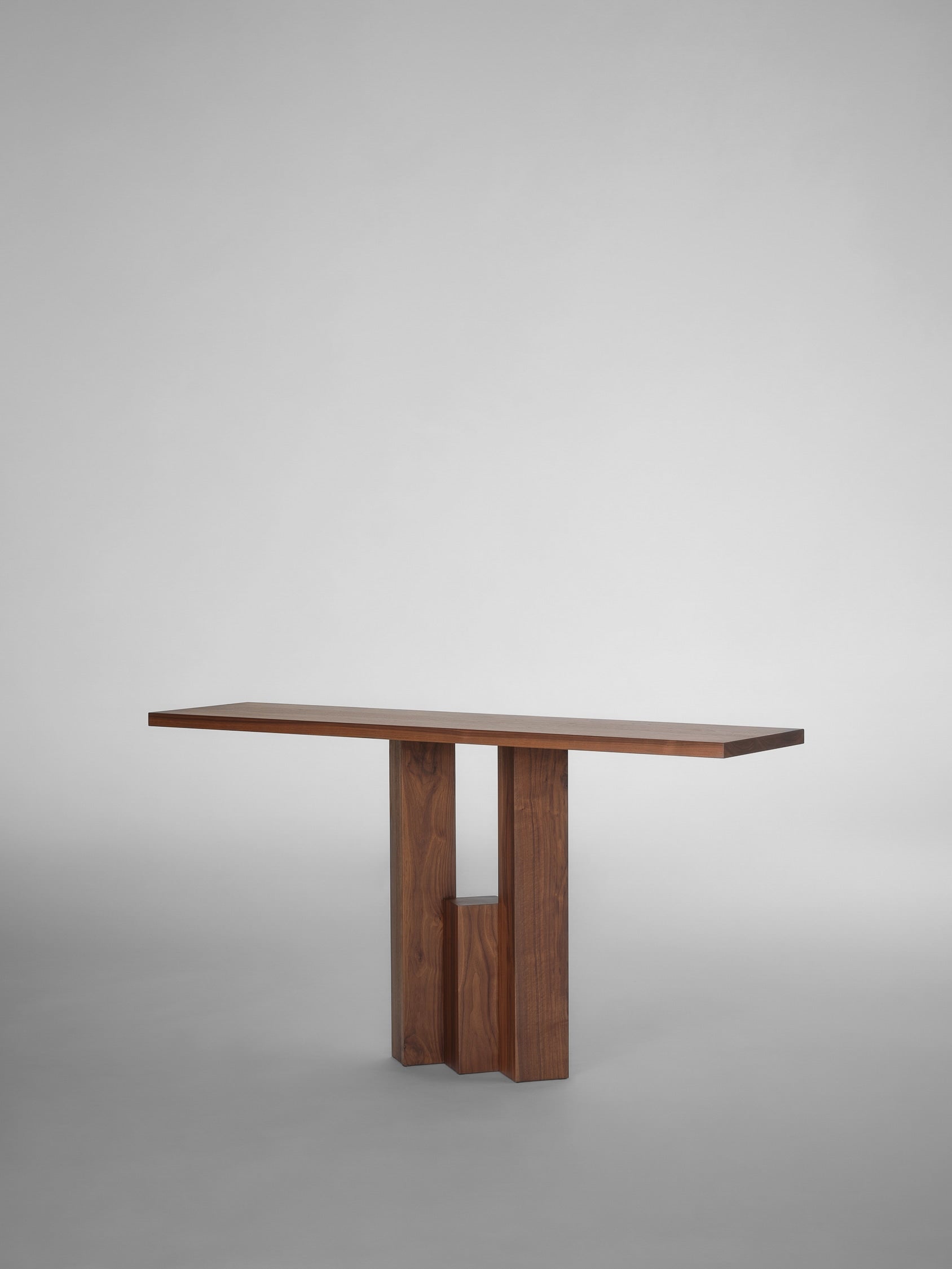 The Mokko Fenestra Console features a modern rectangular top and geometric base, photographed on a light gray background—a striking example of customizable furniture inspired by Brick Expressionism.