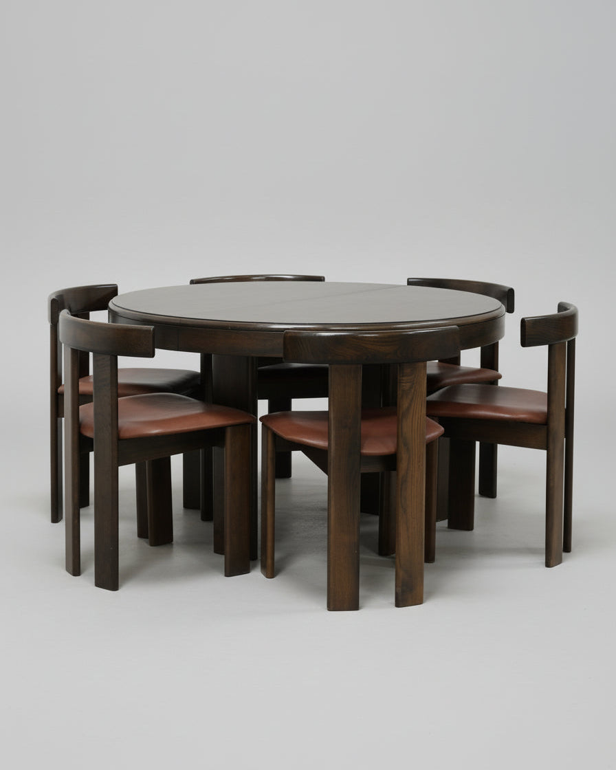 Round walnut dining table with six leather chairs by Luigi Vaghi