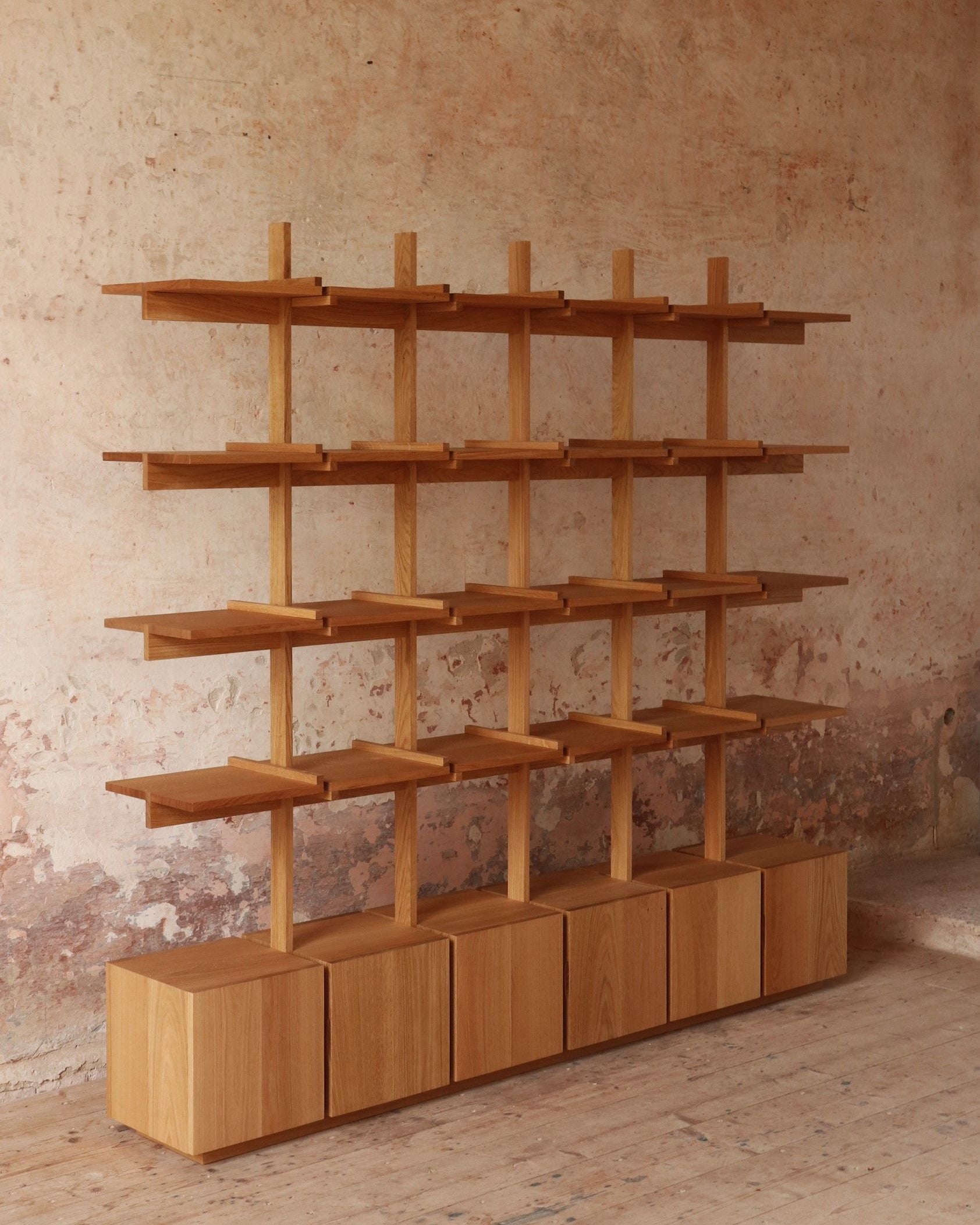Modern wooden bookshelf with geometric grid design and storage cubes