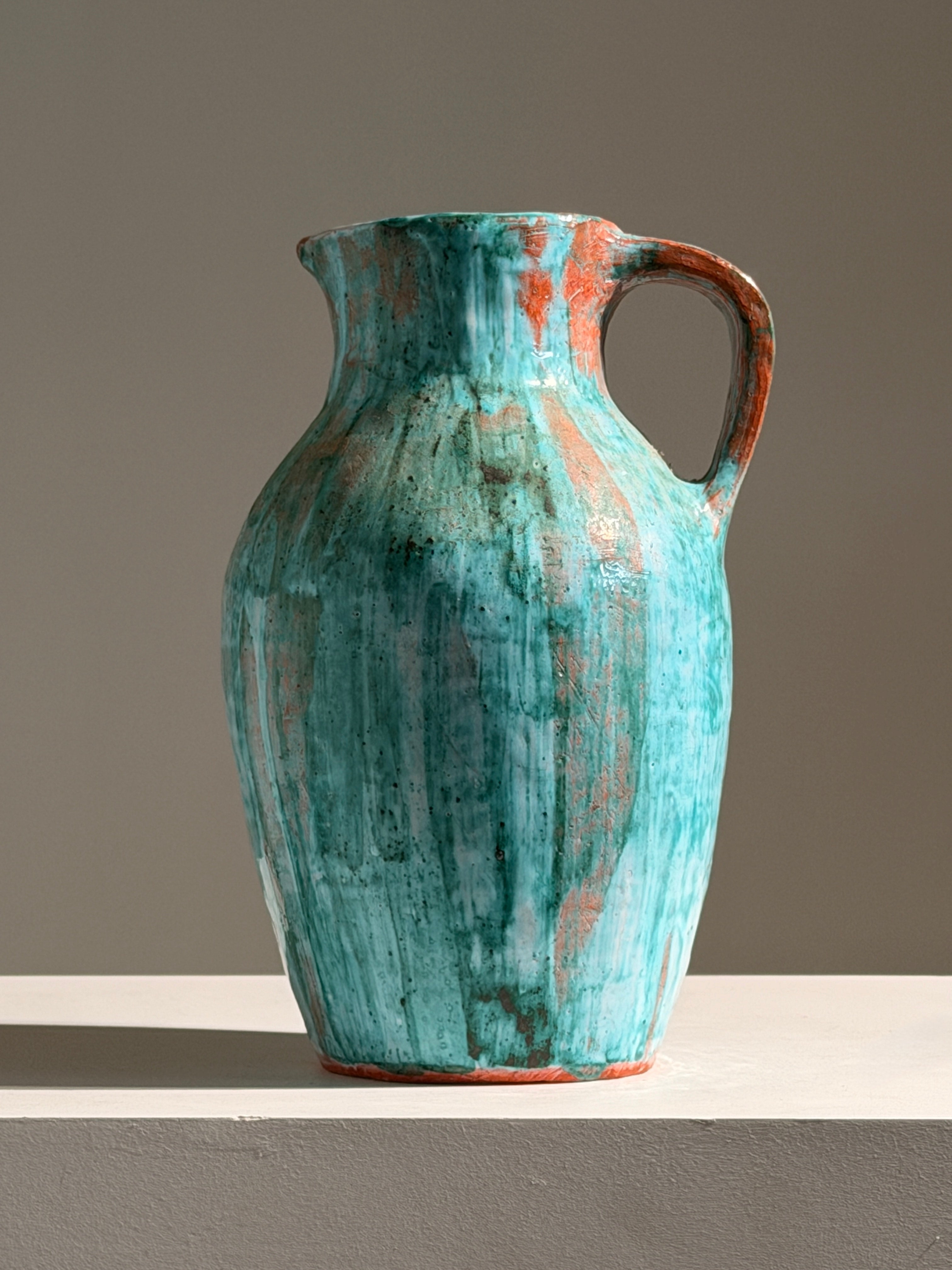 Large pitcher in green glazed earthenware, south of France, circa 1960. — detail view