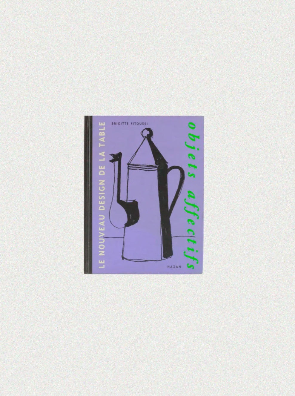 A book cover titled "Objets Affectifs: Le Nouveau Design de la Table" by Brigitte Fitoussi, featuring a minimalistic black illustration of kitchenware on a purple background. The text "Le Nouveau Design De La Table" appears in yellow on the spine, showcasing diseño moderno. Available at Boga Avante Shop.