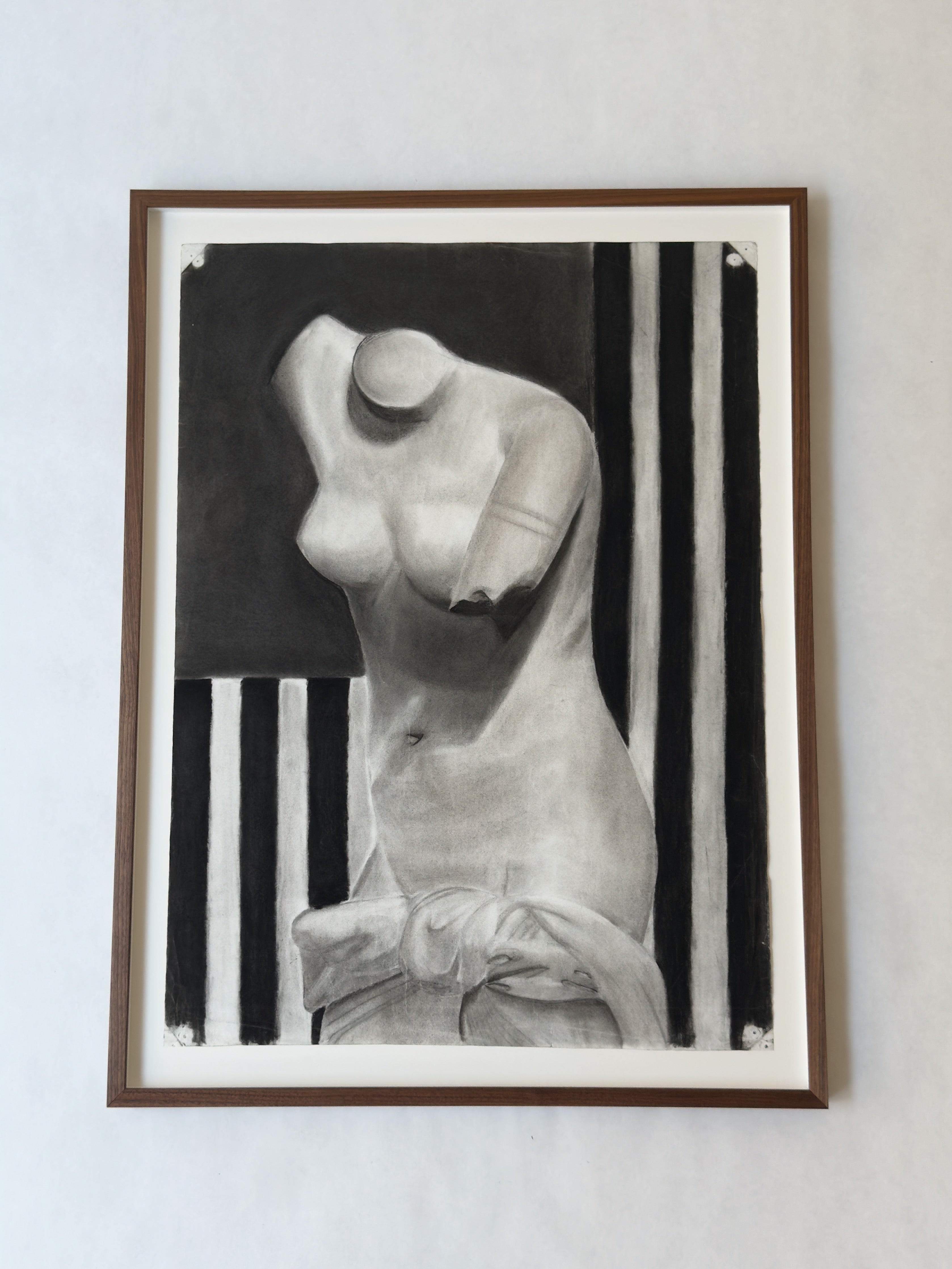The Bust of Venus – Charcoal Drawing, circa 1920s from Galerie Storm showcases a headless, armless female torso sculpture with draped fabric, set against dark rectangles and bold vertical black and white stripes.
